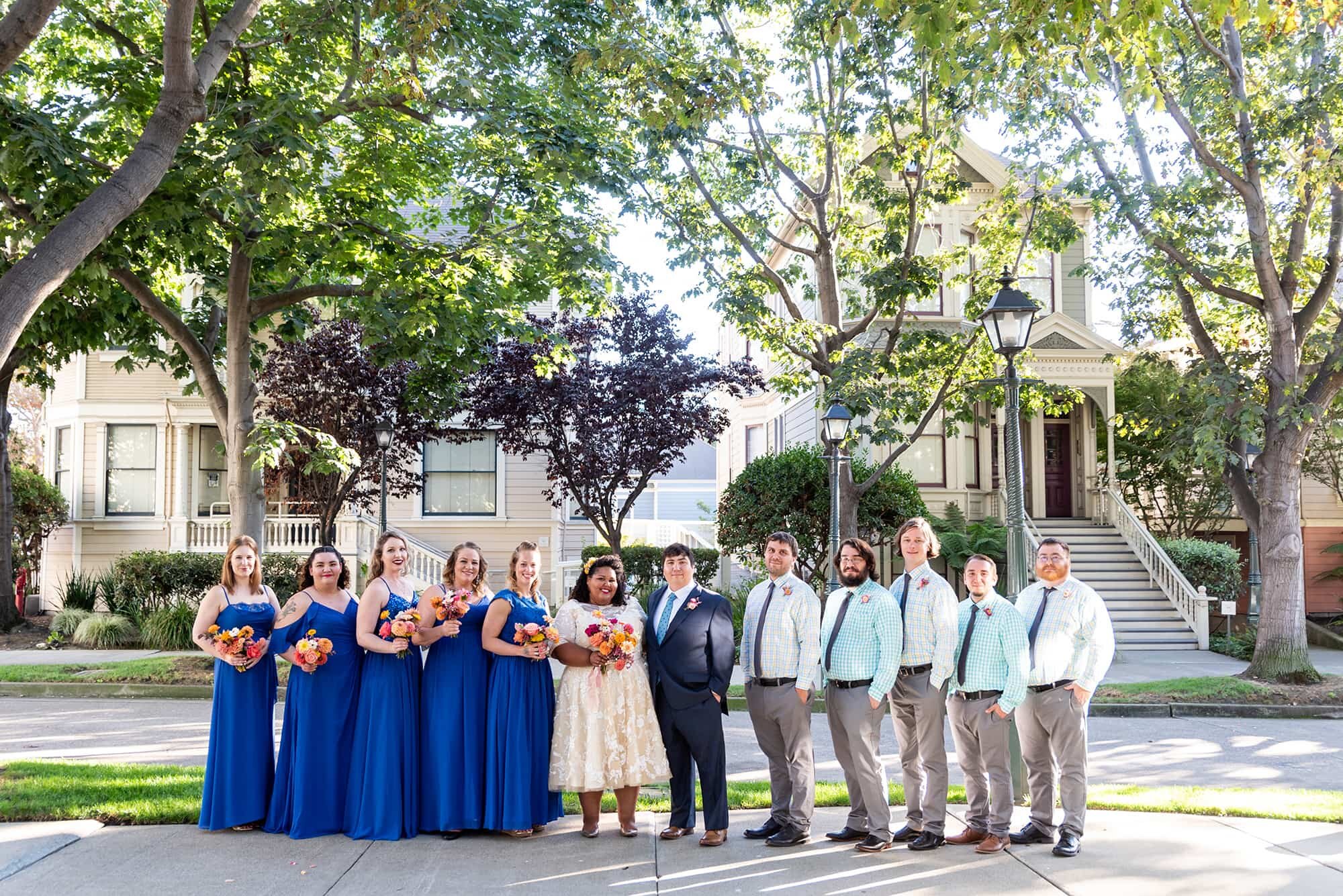 Wedding party lined up on street in Preservation Park