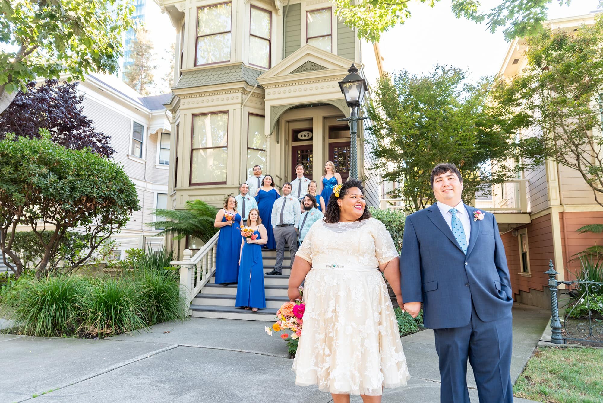 Bride and Groom with wedding party on steps of Victorian House in Oakland