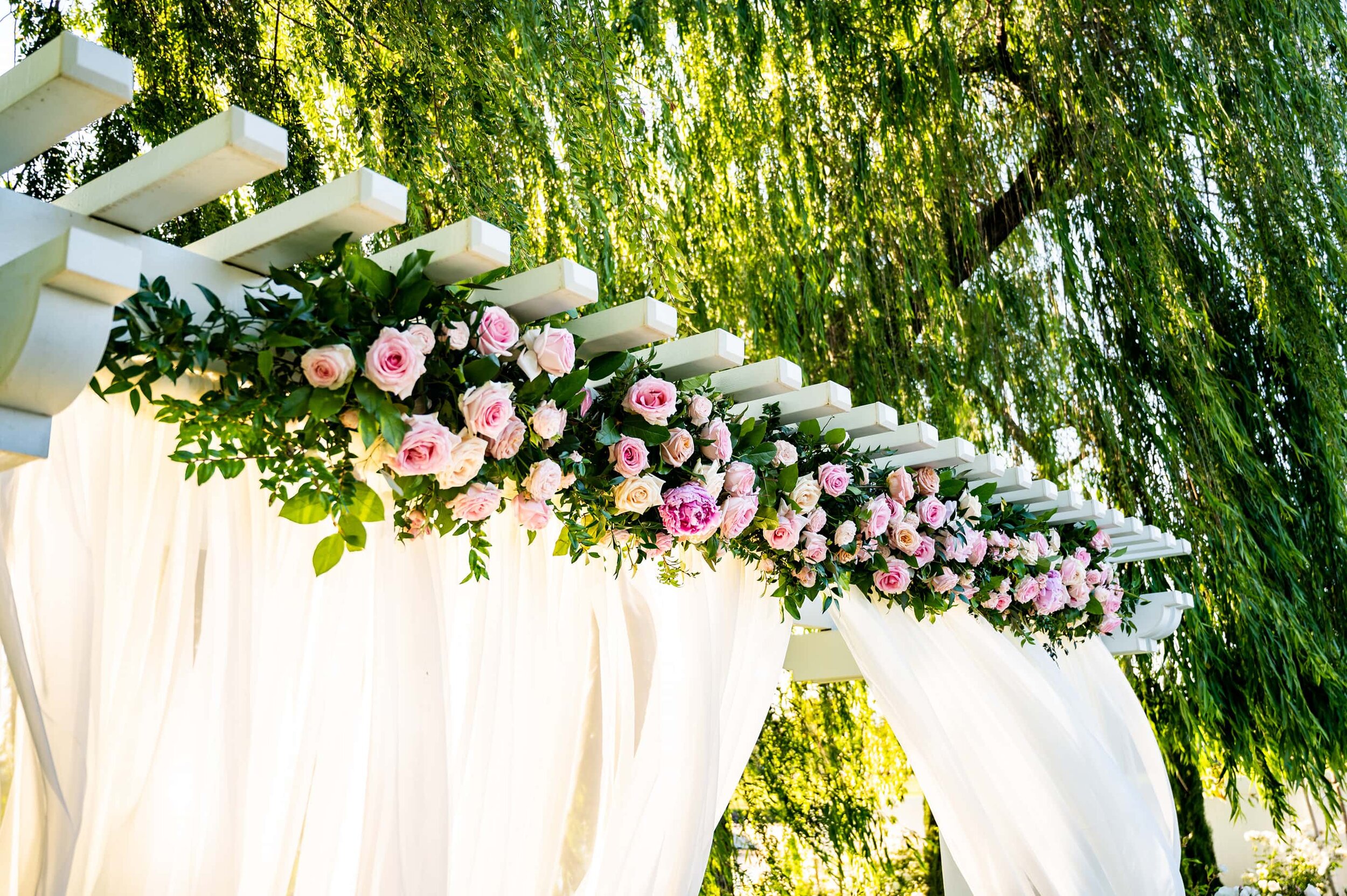 Flower arrangements on pergola at San Ramon Waters