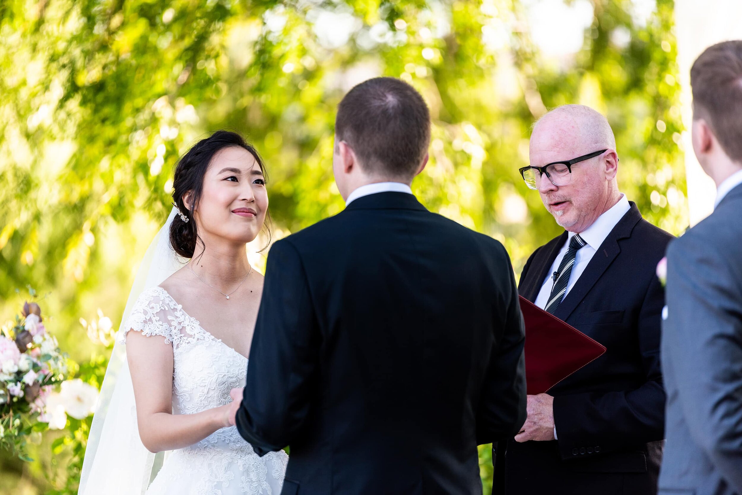 Bride looking at Groom during wedding ceremony 