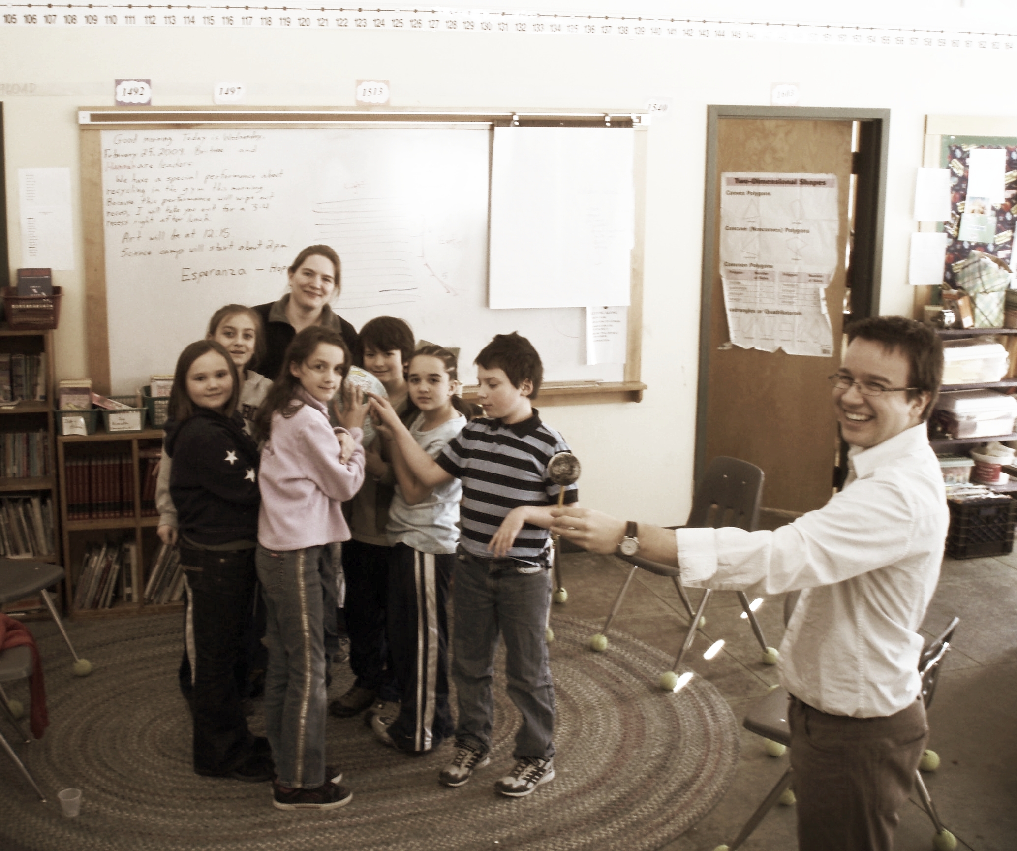 Grade six class of Westshire Elementary School gathered around as I act out the phases of the moon. This lesson was part of a larger astronomy course I taught support by an NSF-funded outreach program.