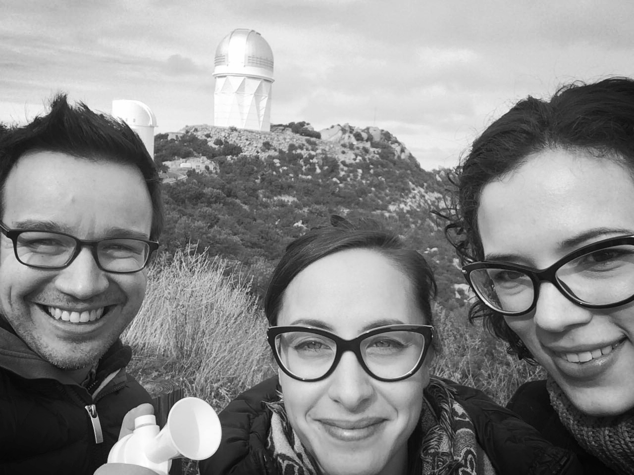 At Kitt Peak National Observatory with two students from University of Turin. We used the Mayall 4m telescope (pictured in the background). Michela (center) brandishes the air horn we were given to scare off bears. 