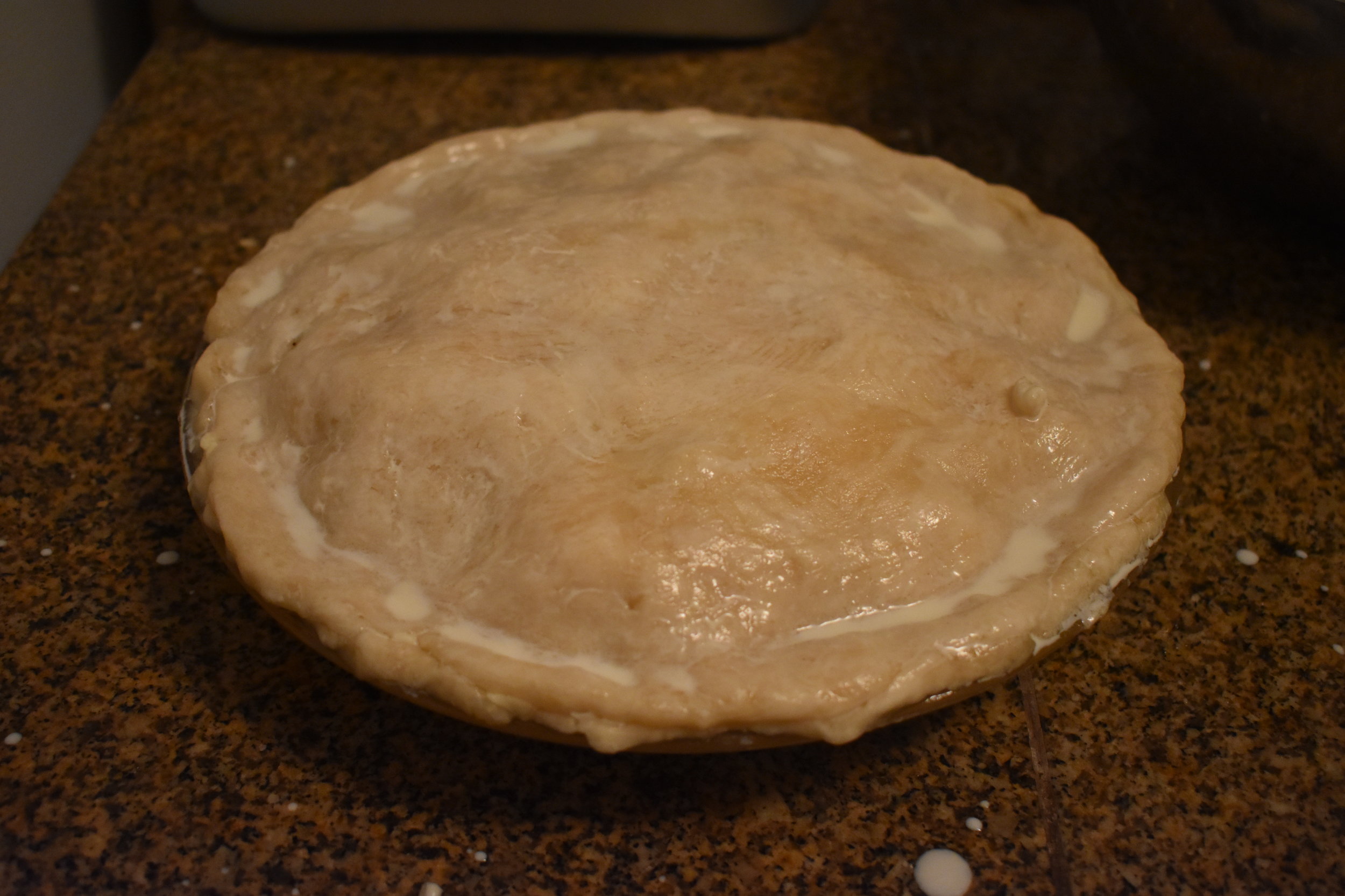 Press and crimp edges, gloss crust with heavy cream.