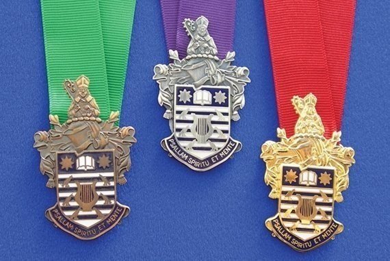 The bronze, silver, and gold medals that choristers can earn after rigorous, oral exams.