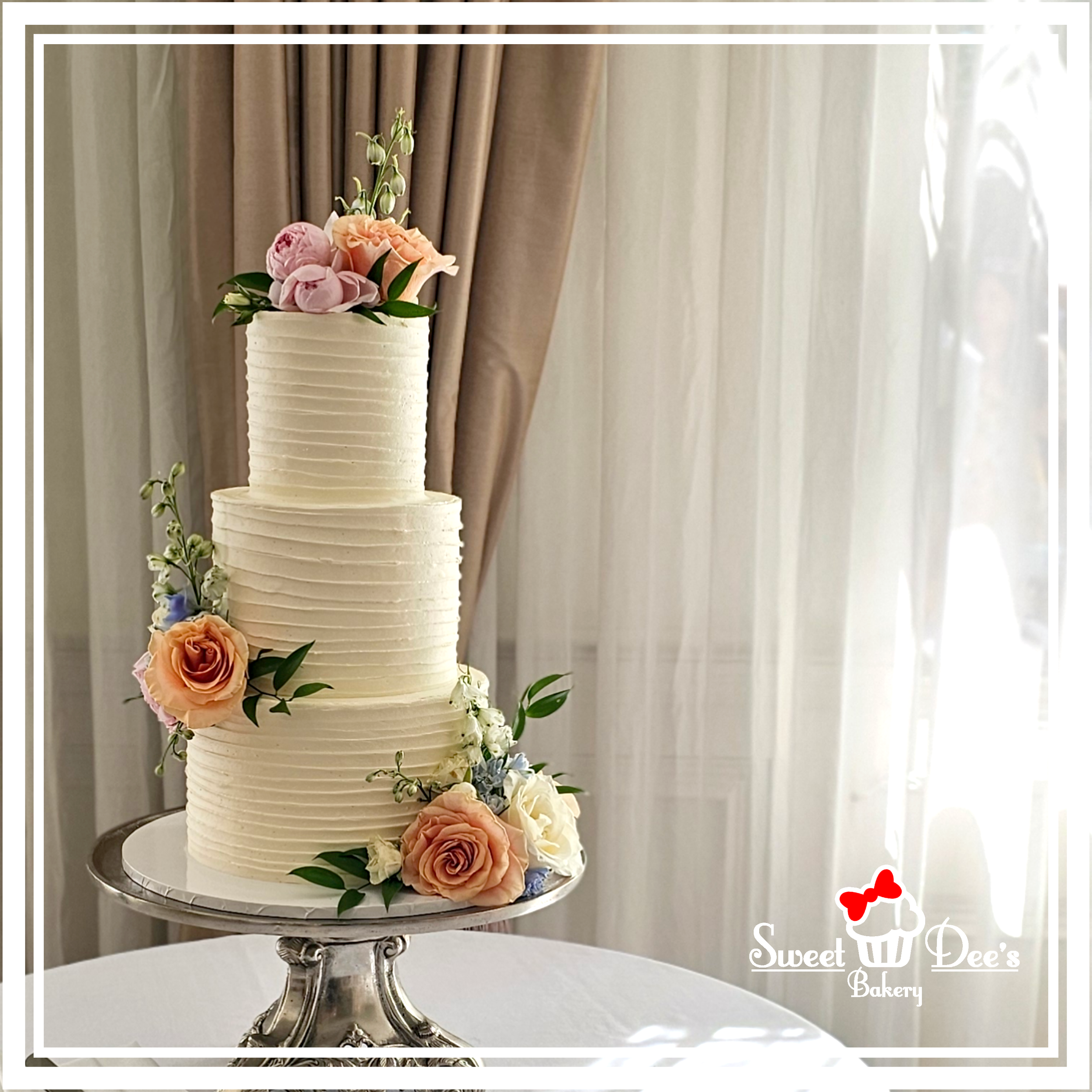 Buttercream Bands Wedding Cake with fresh flowers