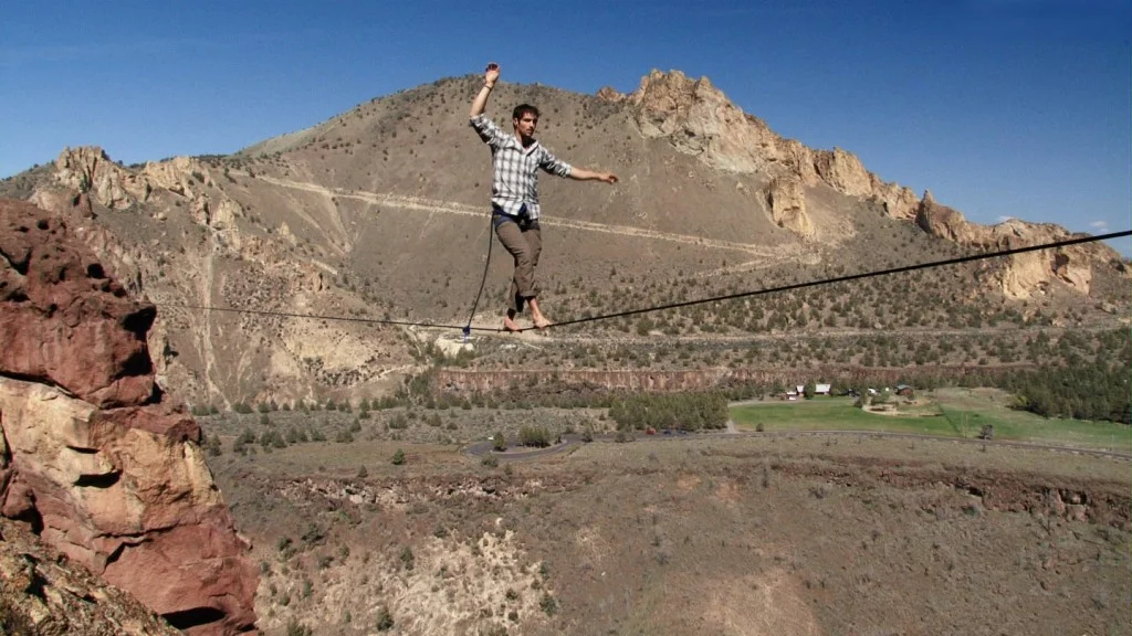 slackliner on Where Swallows Fly highline at Smith Rock State Park