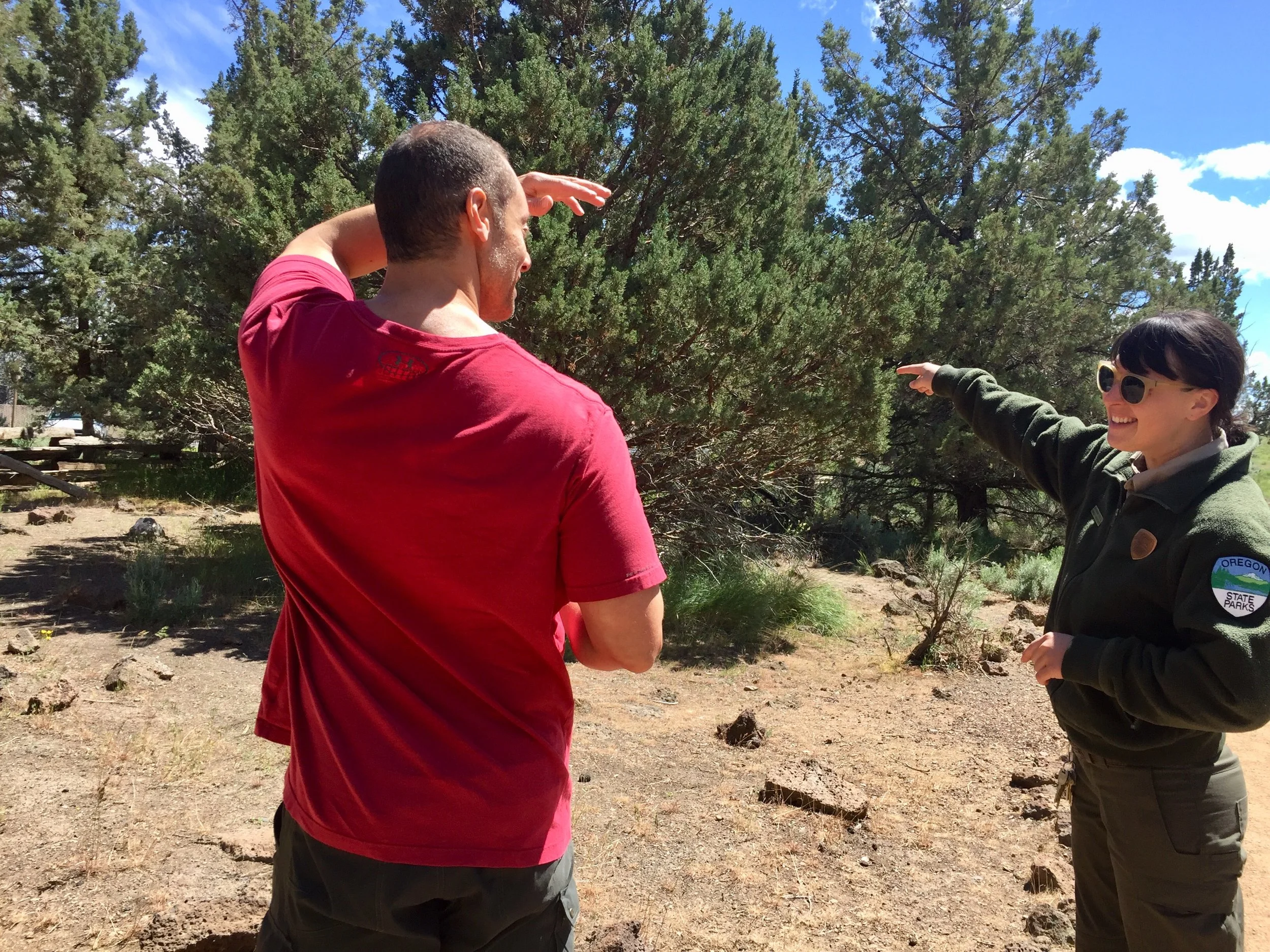 Park Ranger Assistant Savannah Steele makes a visitor smile at Smith Rock State Park as she helps him on his way.