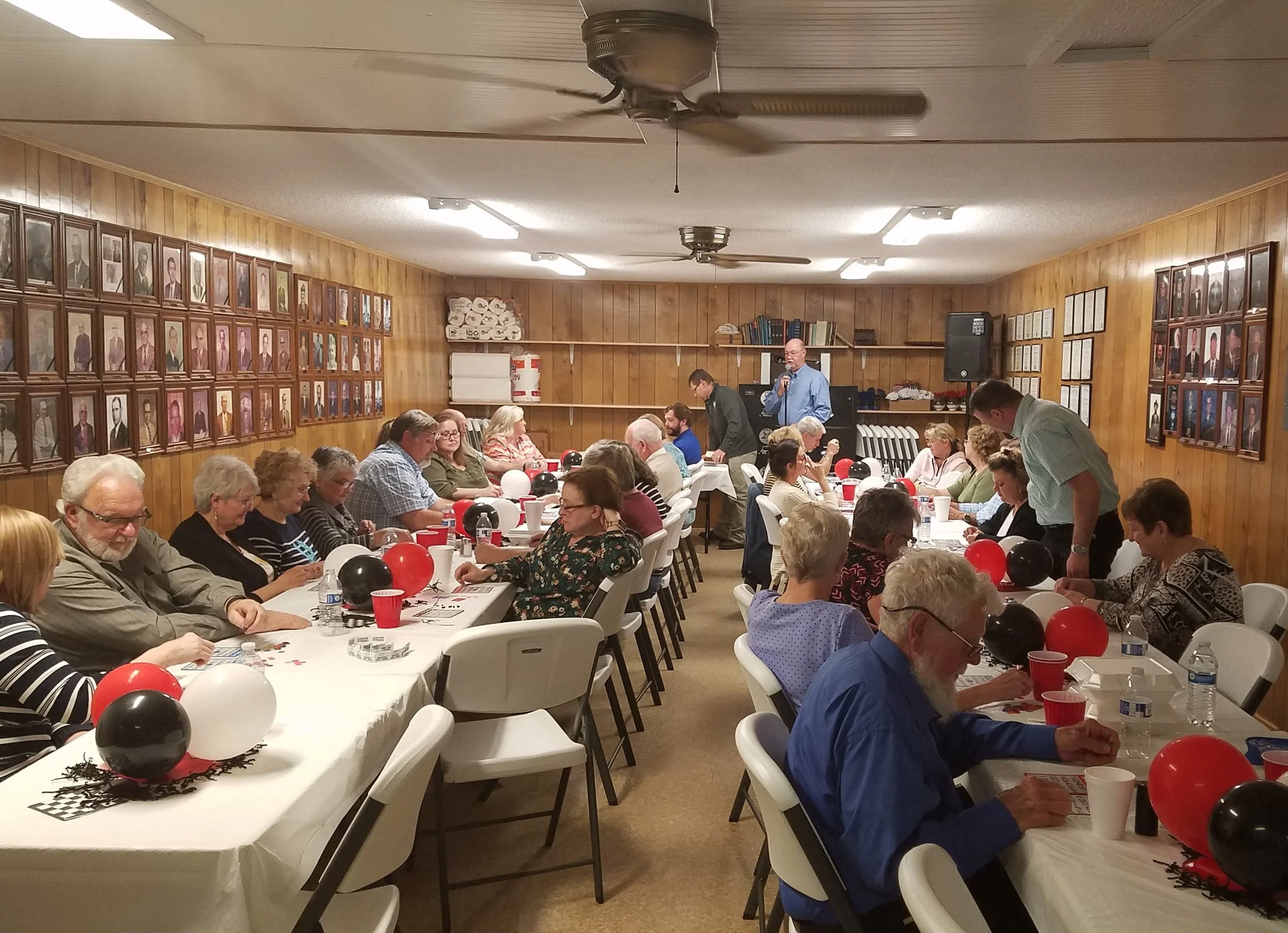 Attendees of the pot luck dinner enjoying a night of bingo!