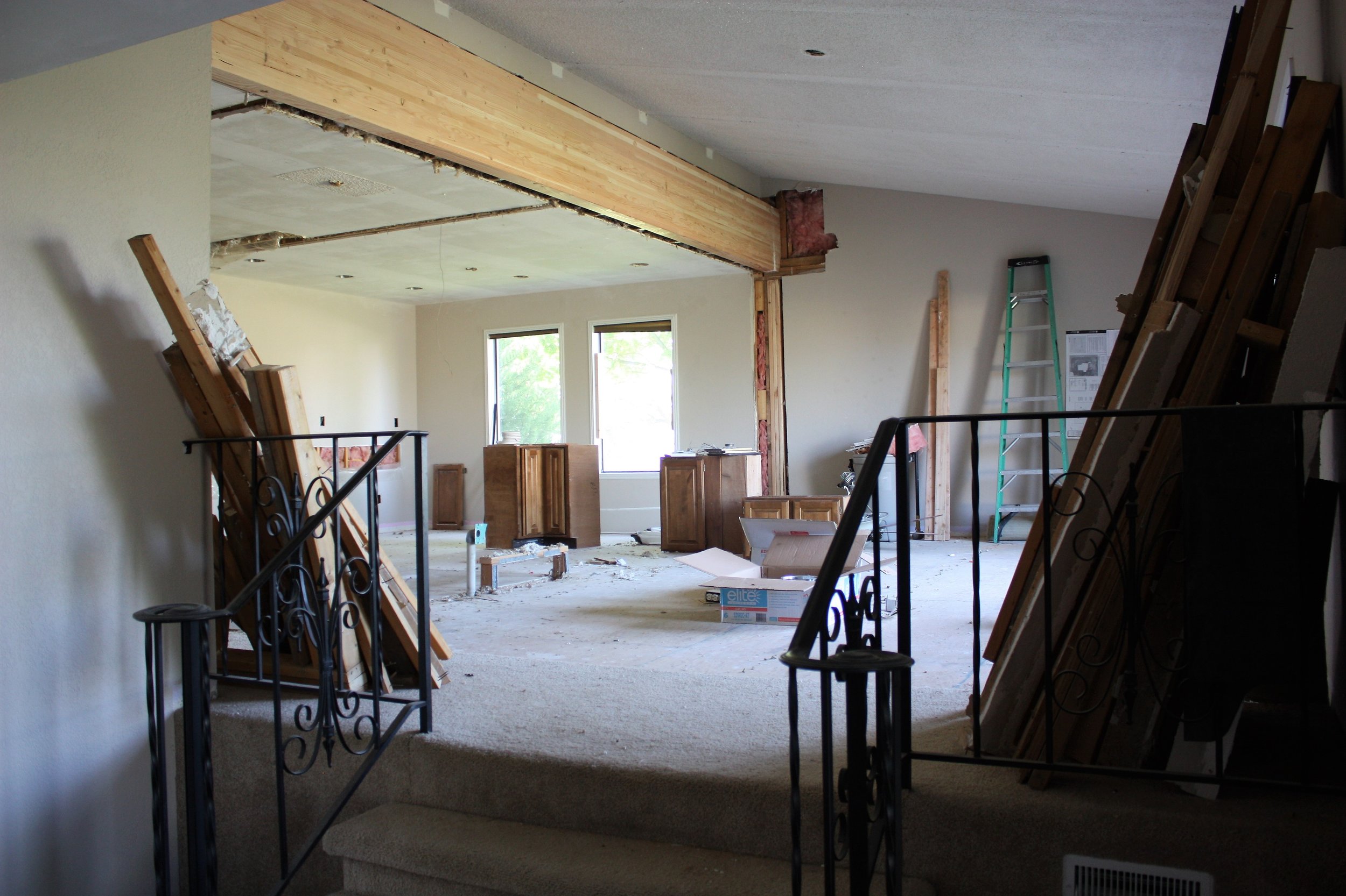 This is the view of our great room from the entryway! You can see our ENORMOUS support beam that our contractors installed in order to get rid of the walls holding the home up. That beam will get stained and look incredible in the space.