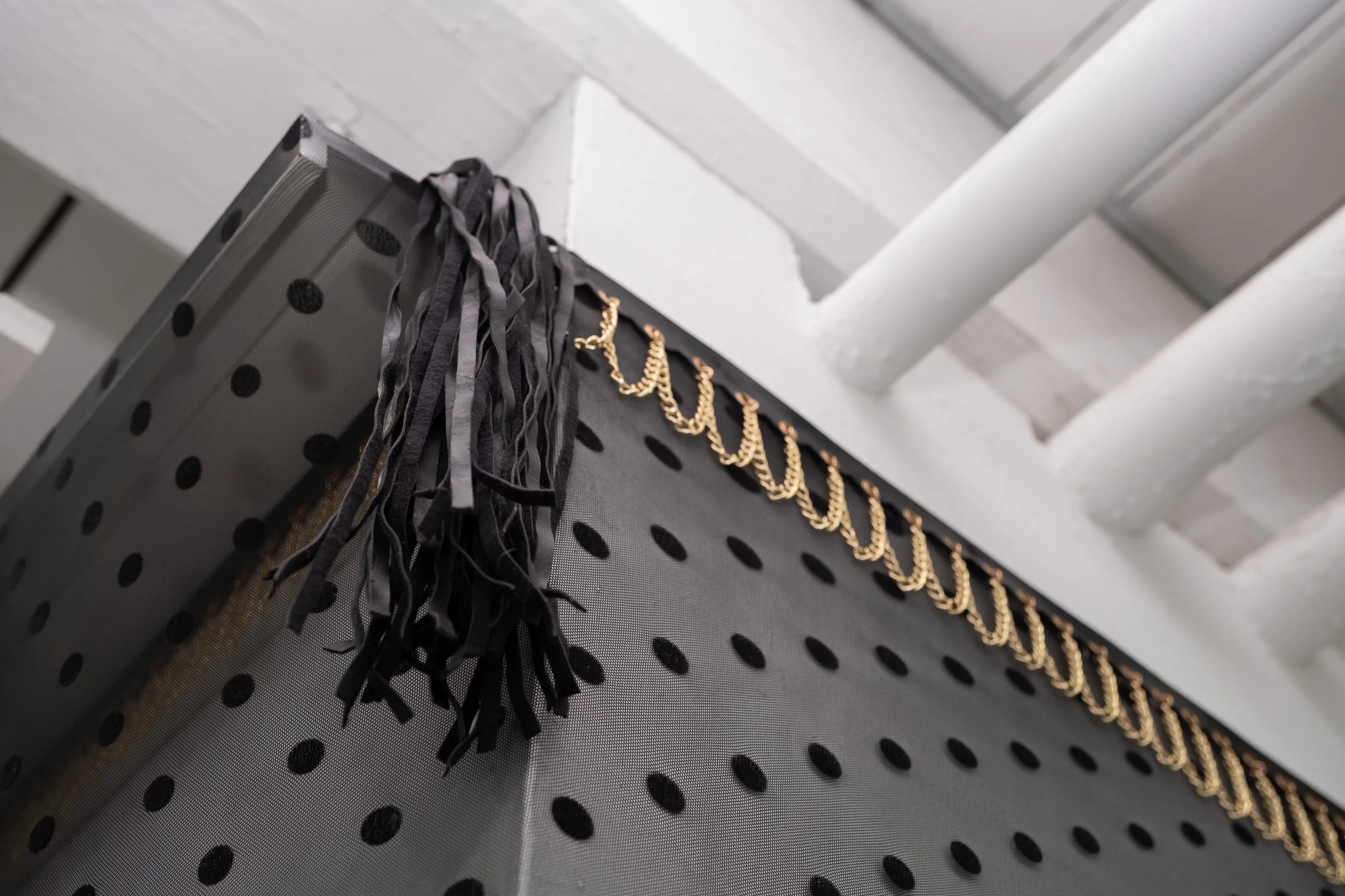   Belle De Jour for Hallway Corner                                         2025. Site-specific installation with spandex mesh, elastic trim, pleather, leather, ceramic, shelves, doorknob                                 152" x 125" x 5" 