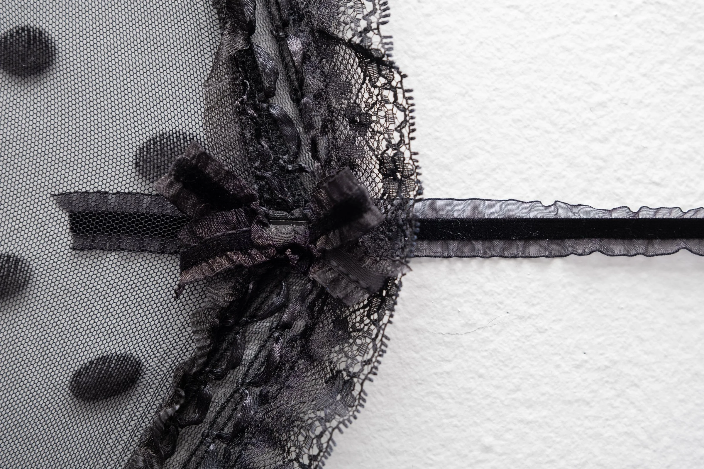   Belle De Jour for Hallway Corner                                         2025. Site-specific installation with spandex mesh, elastic trim, pleather, leather, ceramic, shelves, doorknob                                 152" x 125" x 5" 