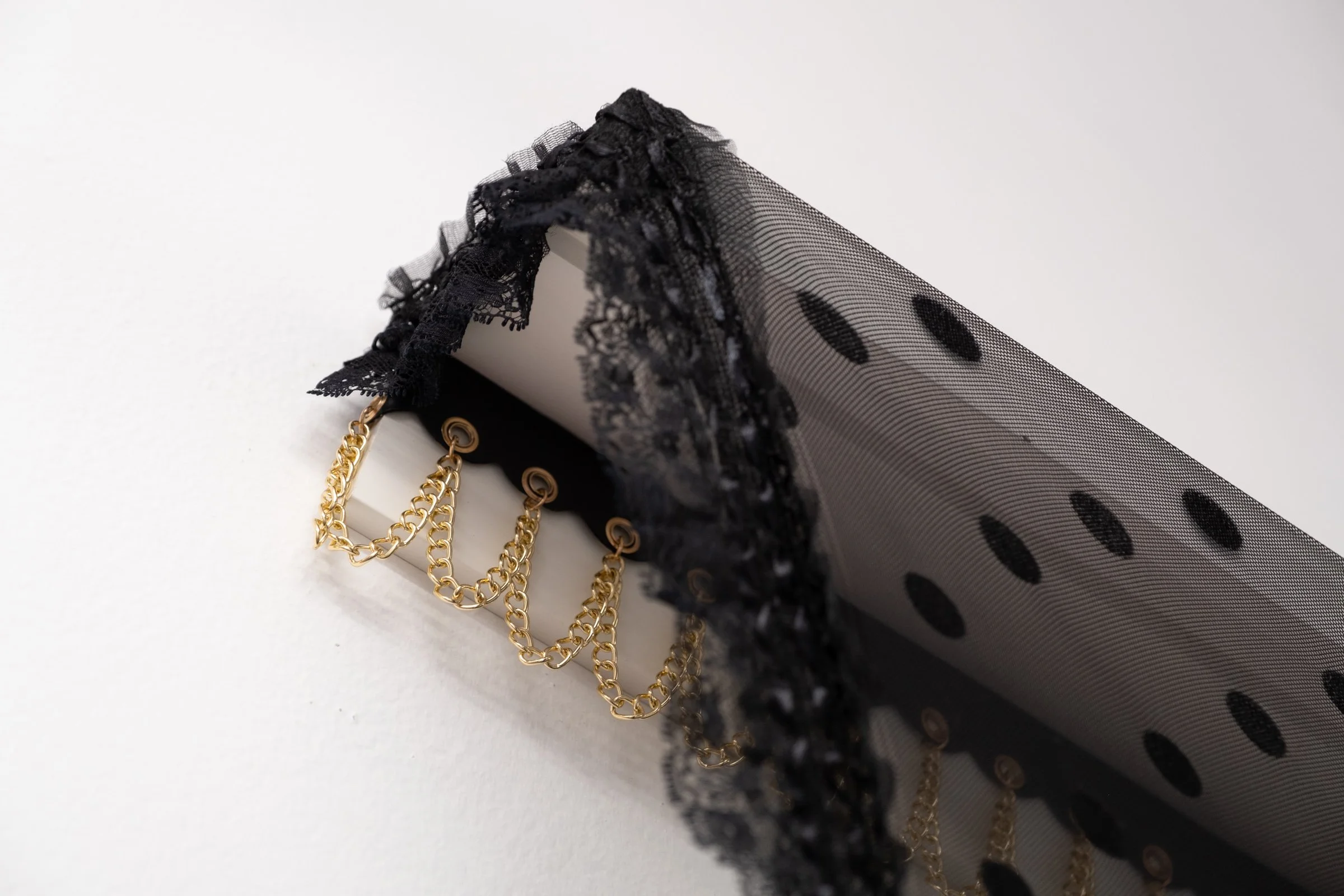   Belle De Jour for Hallway Corner                                         2025. Site-specific installation with spandex mesh, elastic trim, pleather, leather, ceramic, shelves, doorknob                                 152" x 125" x 5" 