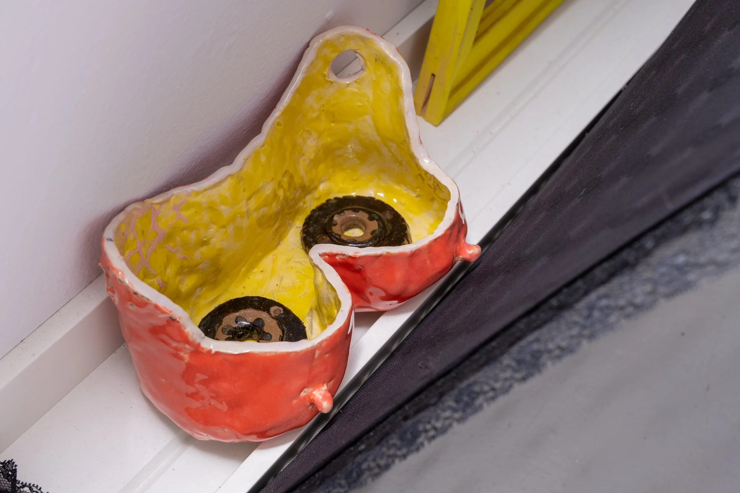   Belle De Jour for Hallway Corner                                         2025. Site-specific installation with spandex mesh, elastic trim, pleather, leather, ceramic, shelves, doorknob                                 152" x 125" x 5" 