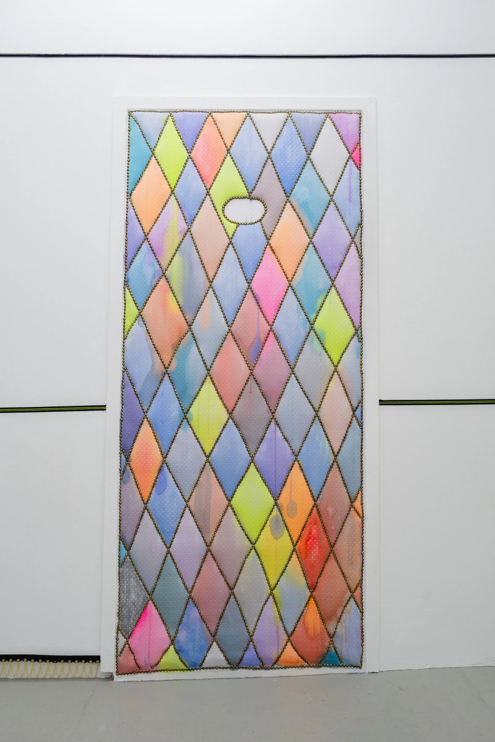   128 (for OyG)                                               2025. Site-specific painting with neoprene, fluid acrylic, batting, upholstery tacks, nails            40.5" x 87.5" x 5" 