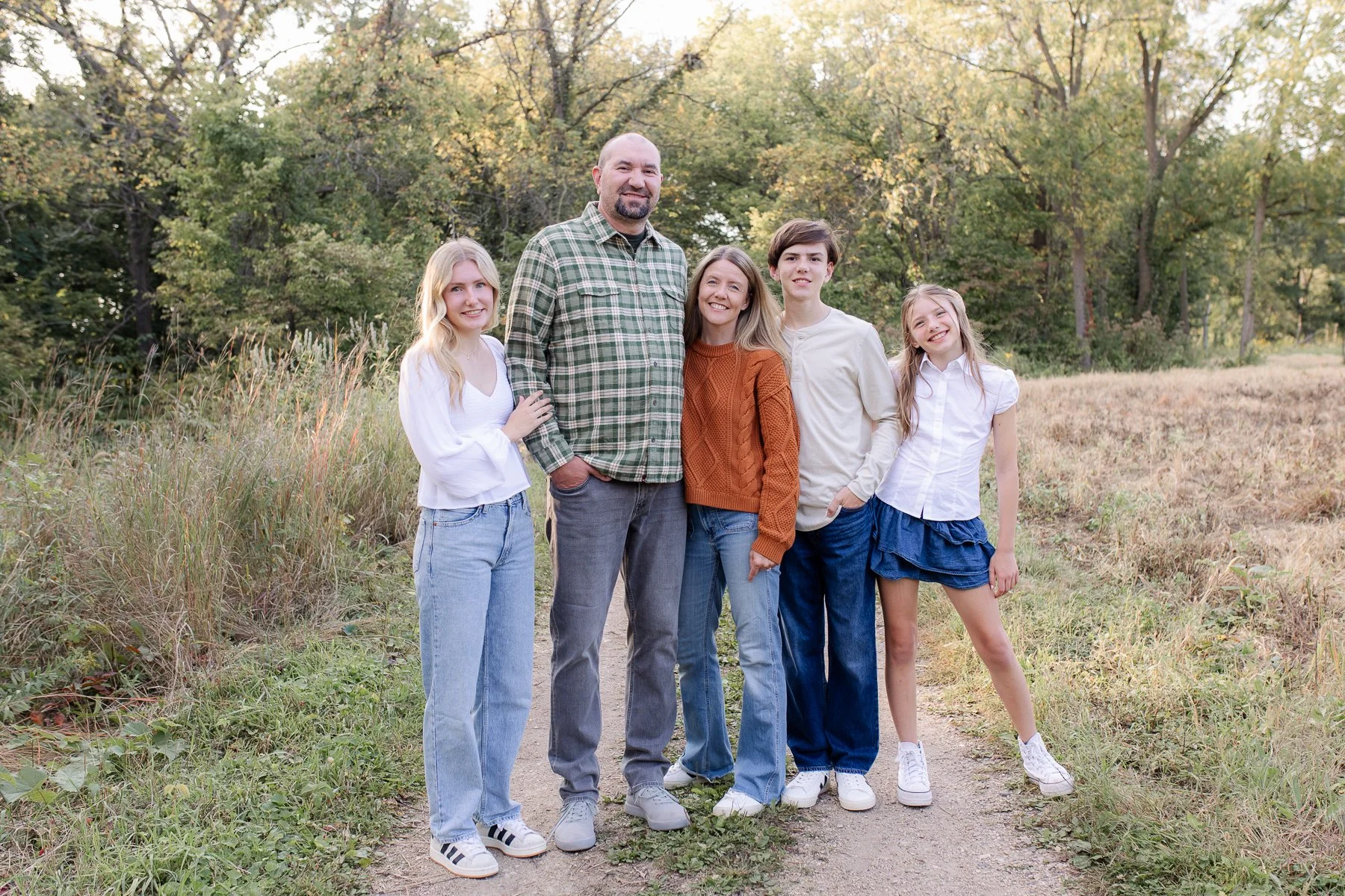 Family of five standing outdoors