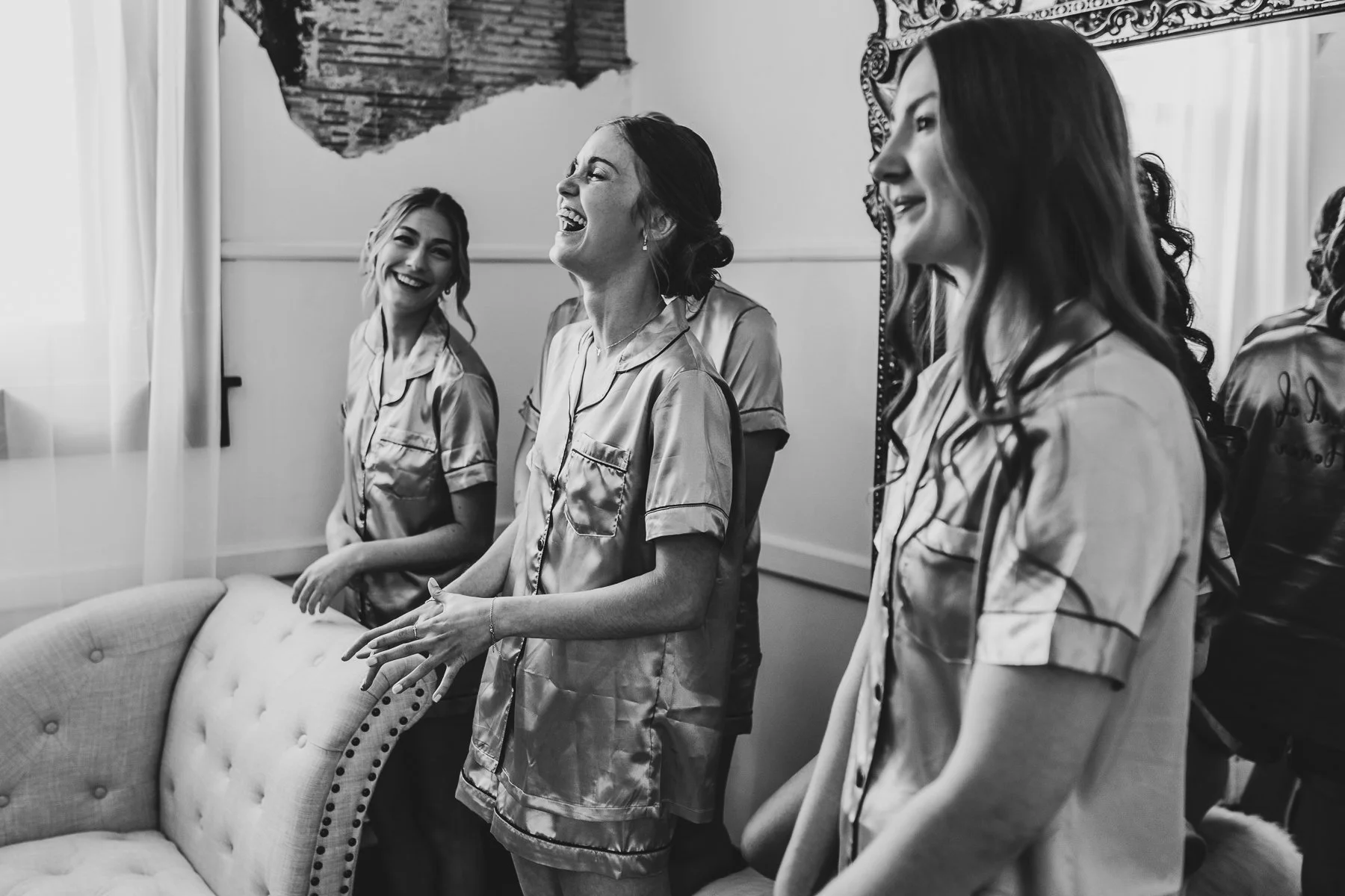 Bridesmaids looking at bride