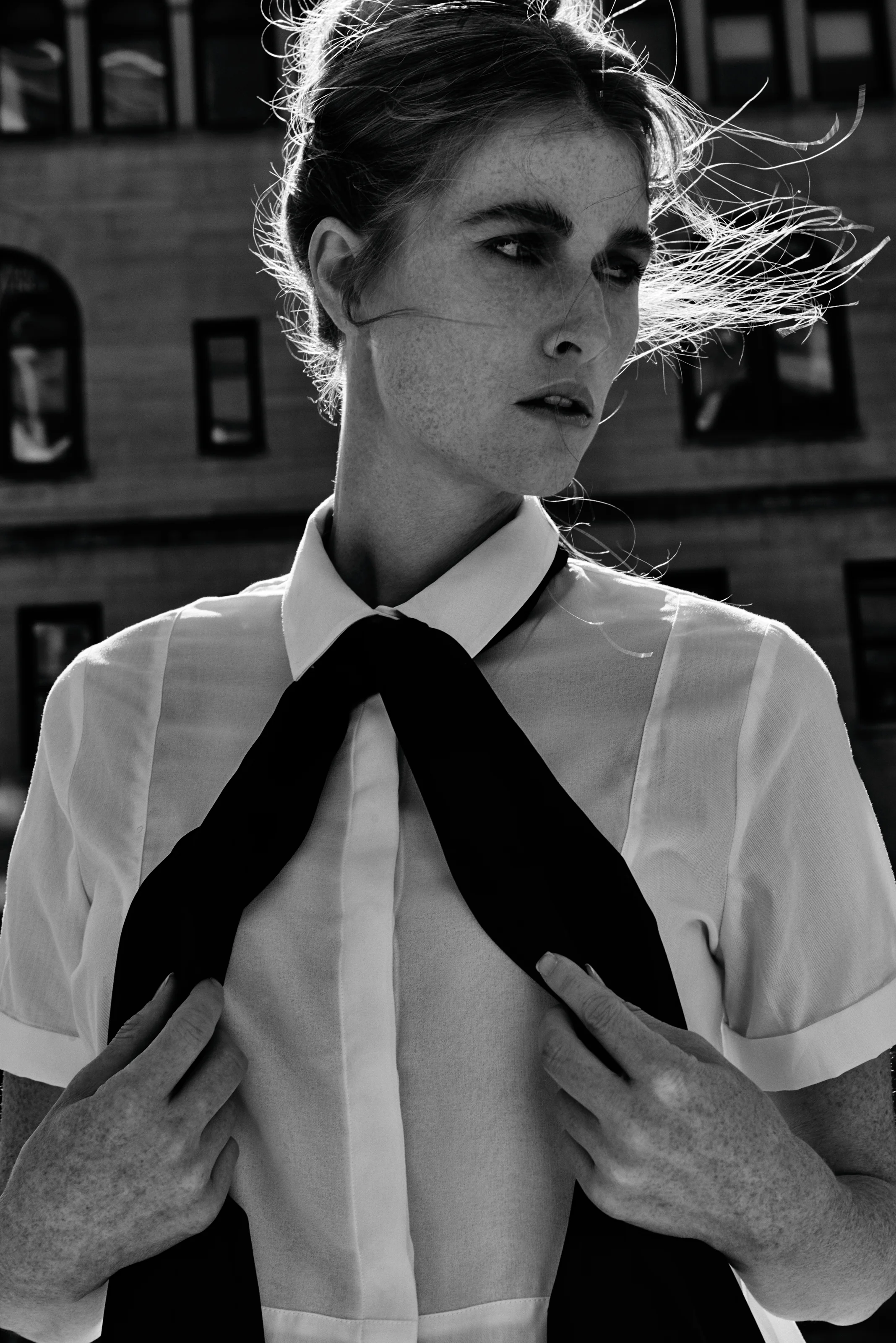  Work by New York fashion consultant and wardrobe stylist Kate Moroney featuring profile close-up of model in white shirt and black scarf with clean, minimal styling 