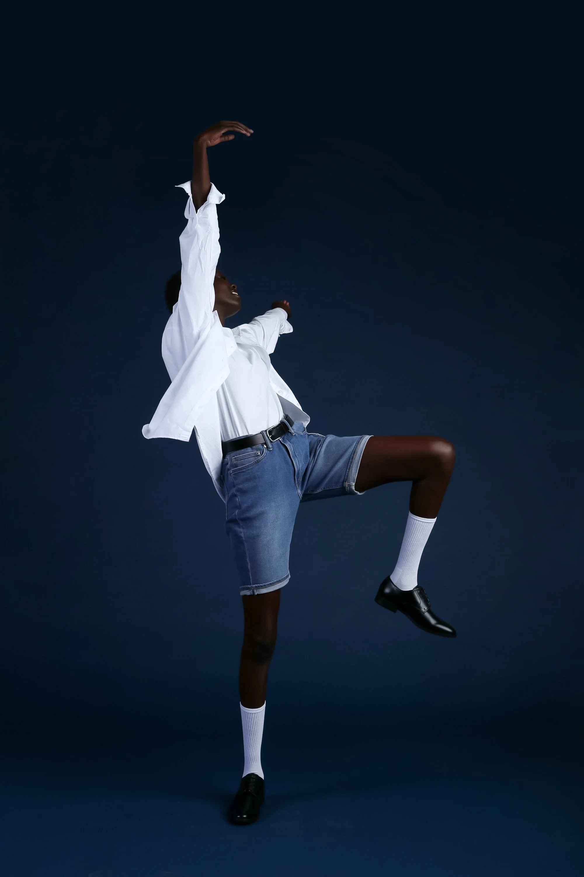  New York fashion consultant Kate Moroney styling ethereal editorial shot of girl dancing in shorts and oversized white button-up 