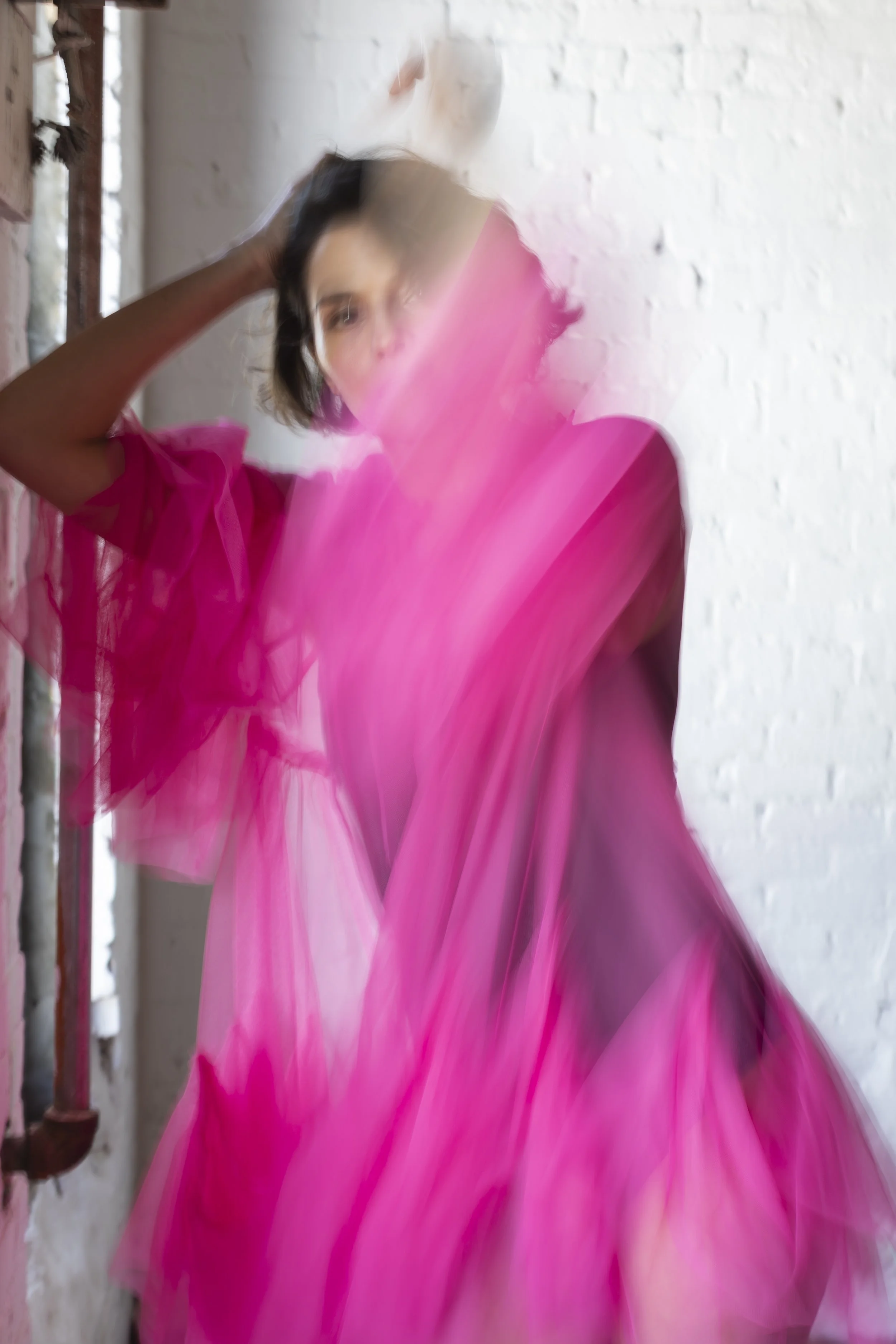  New York fashion stylist and consultant Kate Moroney featuring ethereal film-shot image of model in pink sheer dress with soft, editorial aesthetic 