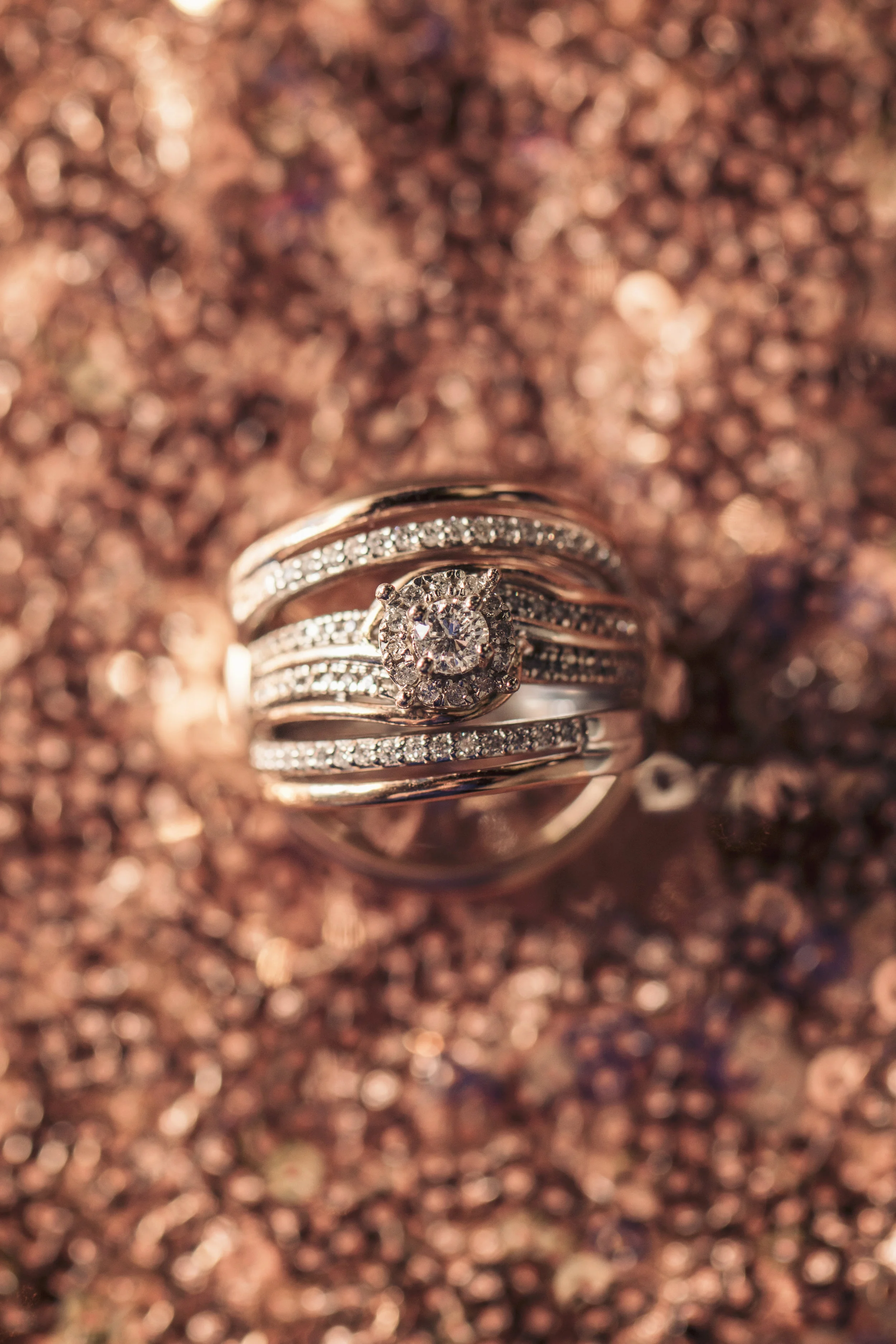 I am super pleased with this ring shot. WOW! Talk about a ring! GOOD JOB, ALEX!! I love the rose gold over the pink sequined tablecloth.