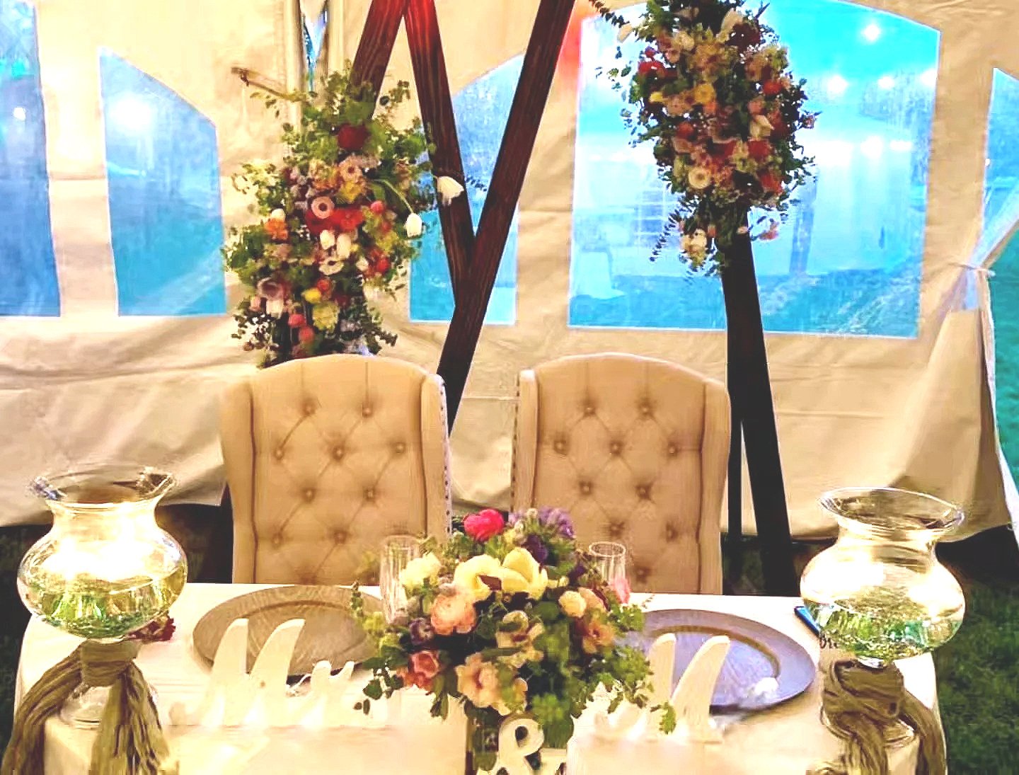  The sweetheart table, surrounded by flowers at this elegant wedding. 