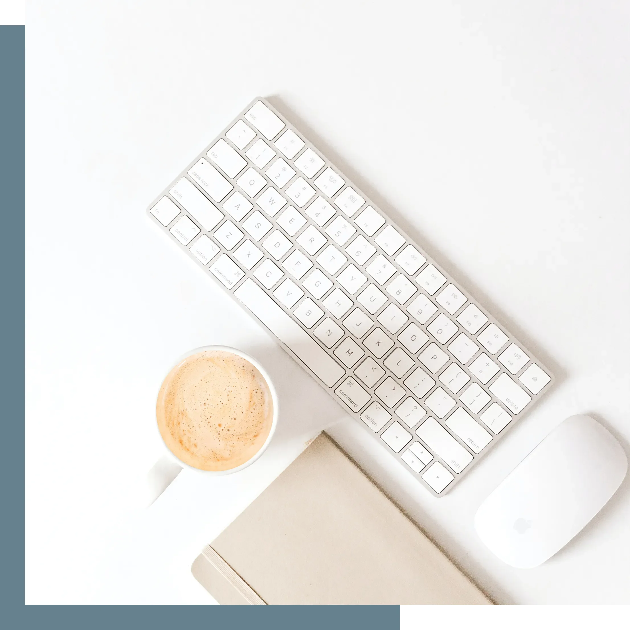 Keyboard, mouse, and latte on a desk surface