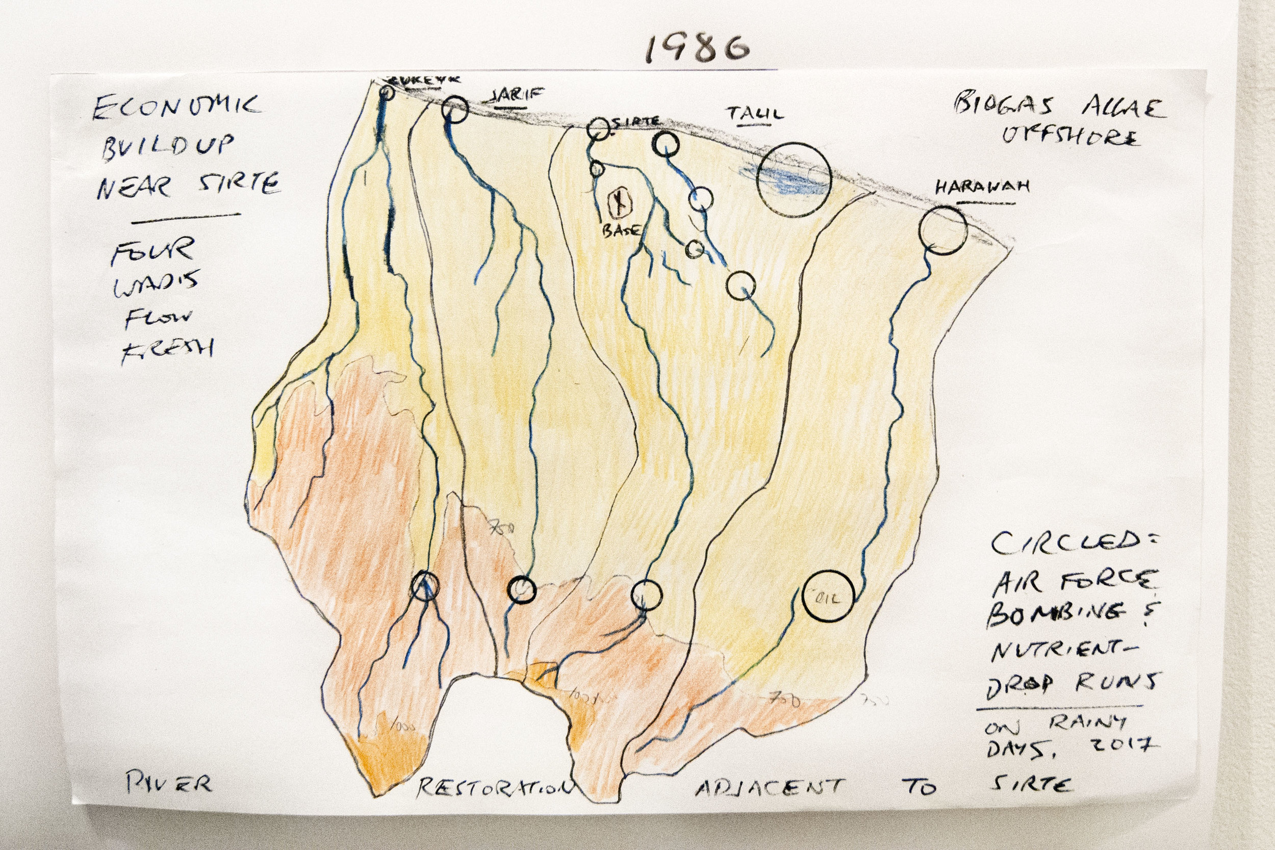 A more accurate study of wadis as they flow into the Sea to the east and west of Sirte. This is based on a 1:500,000 TPC aeronautical chart, with wadis named. Elevations are shown for above 750 ft and above 1000 ft. Encircled are wadi areas smothered in alluvia, or blocked by sand. They exist along the coast, and well inland. The Shadow Defense Secretary proposes that the coastal barriers be removed by crews of work- and food-hungry refugees, who’d finally earn a living. Methods have been tested with a similarly-blocked wadi near Dubai (see Bomb magazine, Dec 2011). The sites well inland, and some parts of the wadis now with braiding, could have troughs and craters bombed out by B-2 bombers. Those sites might as well have no people; a warning could be issued beforehand, to be certain. Such bombing runs - conducted for solely ecological and economic-development reasons, being restoration of water supply, even soggy lands - could win the adulation of the people there, native and refugee alike. Next in production: a study of all wadi-Sea sand-dune barriers in Libya, aimed at starting a massive work program for the refugees now there. This would be coordinated with macroalgae sea industry, for local biofuel. Command would come from freshly-trained Libyan Coast Guard officers.