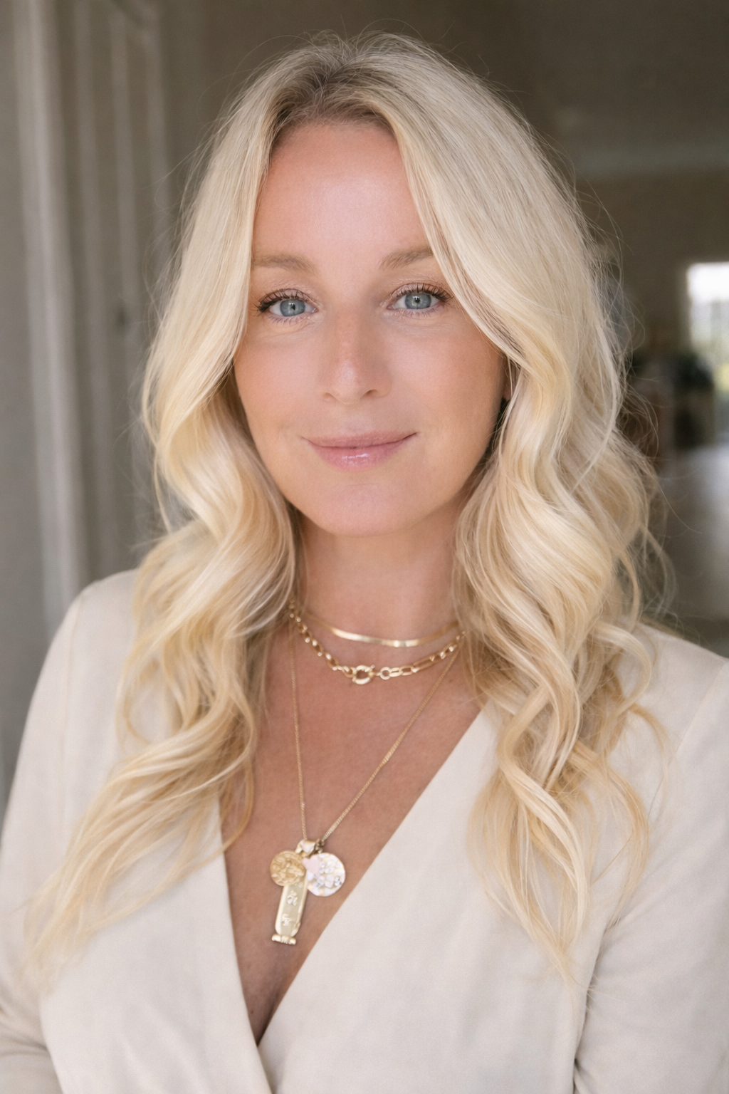 Elegant portrait with layered gold jewelry.png