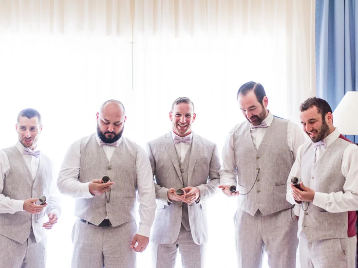 Groomsmen enjoy their pocket-watches at this destination wedding in Mexico