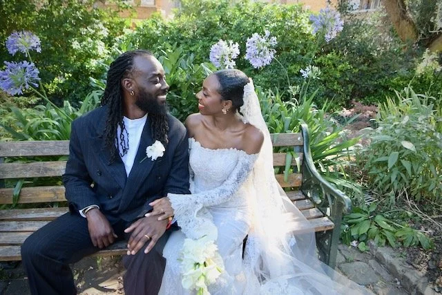Joyful bride and groom sharing a romantic moment together on a garden bench during their London wedding, captured by a London wedding photographer