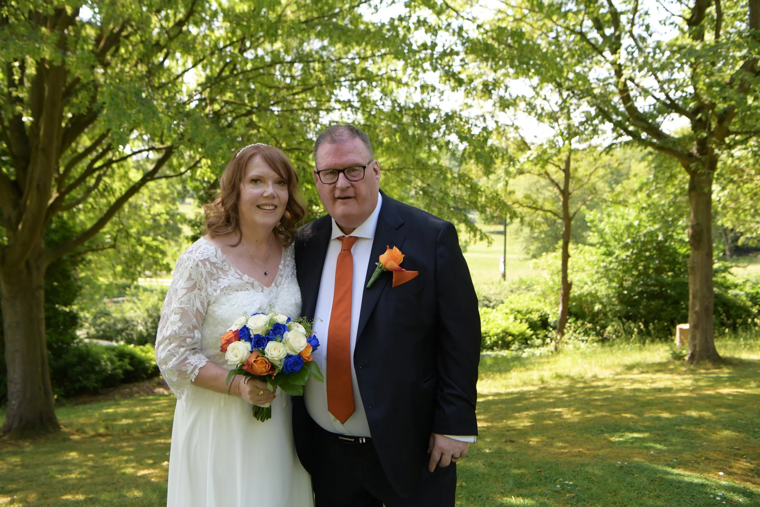 Newly married couple in a sunlit garden, photographed by a London wedding photographer 