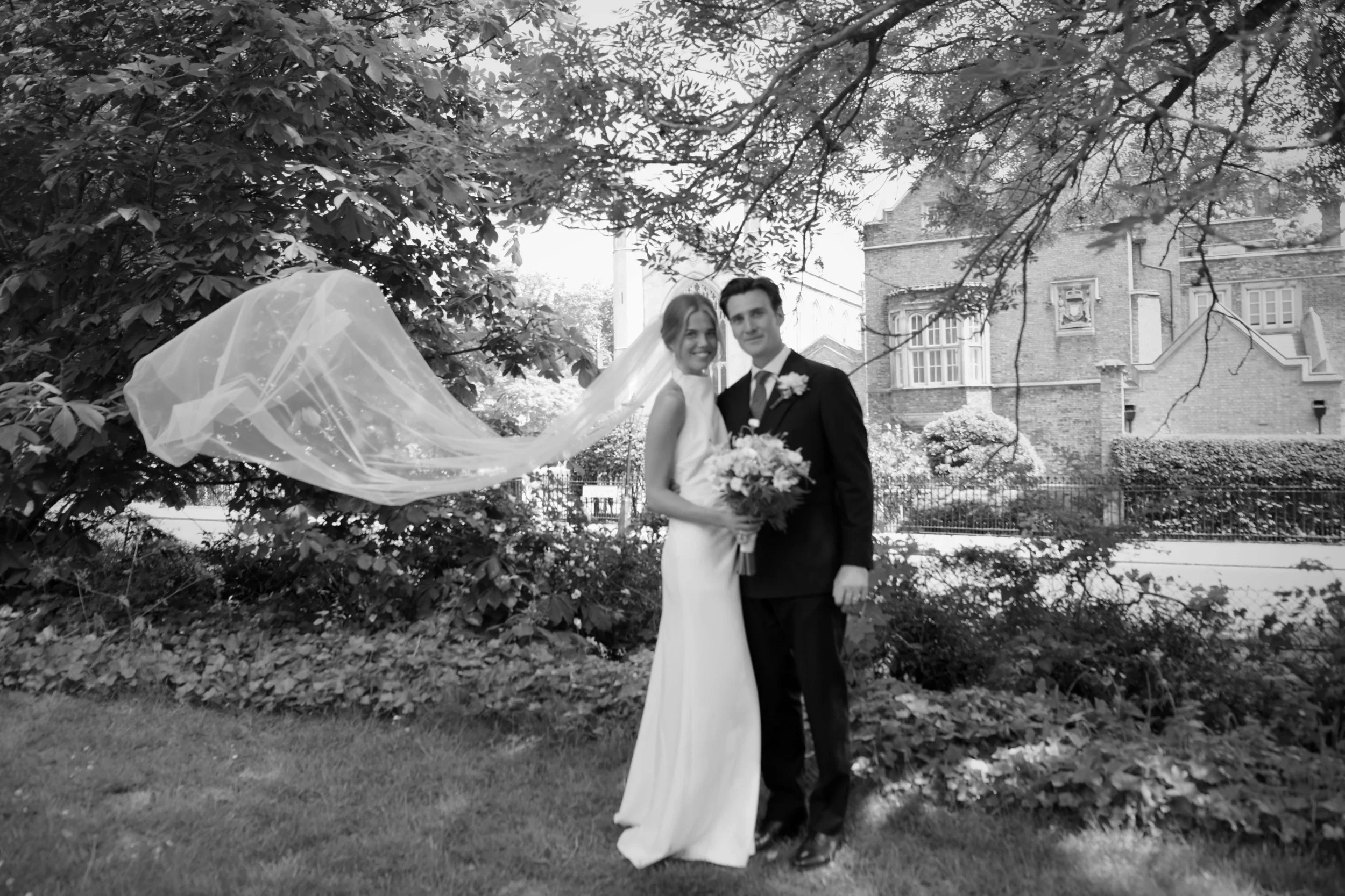 Wedding portrait in Regent’s Park, London, capturing a romantic newlywed moment beneath elegant trees and historic architecture. Perfect inspiration for luxury London wedding photography.