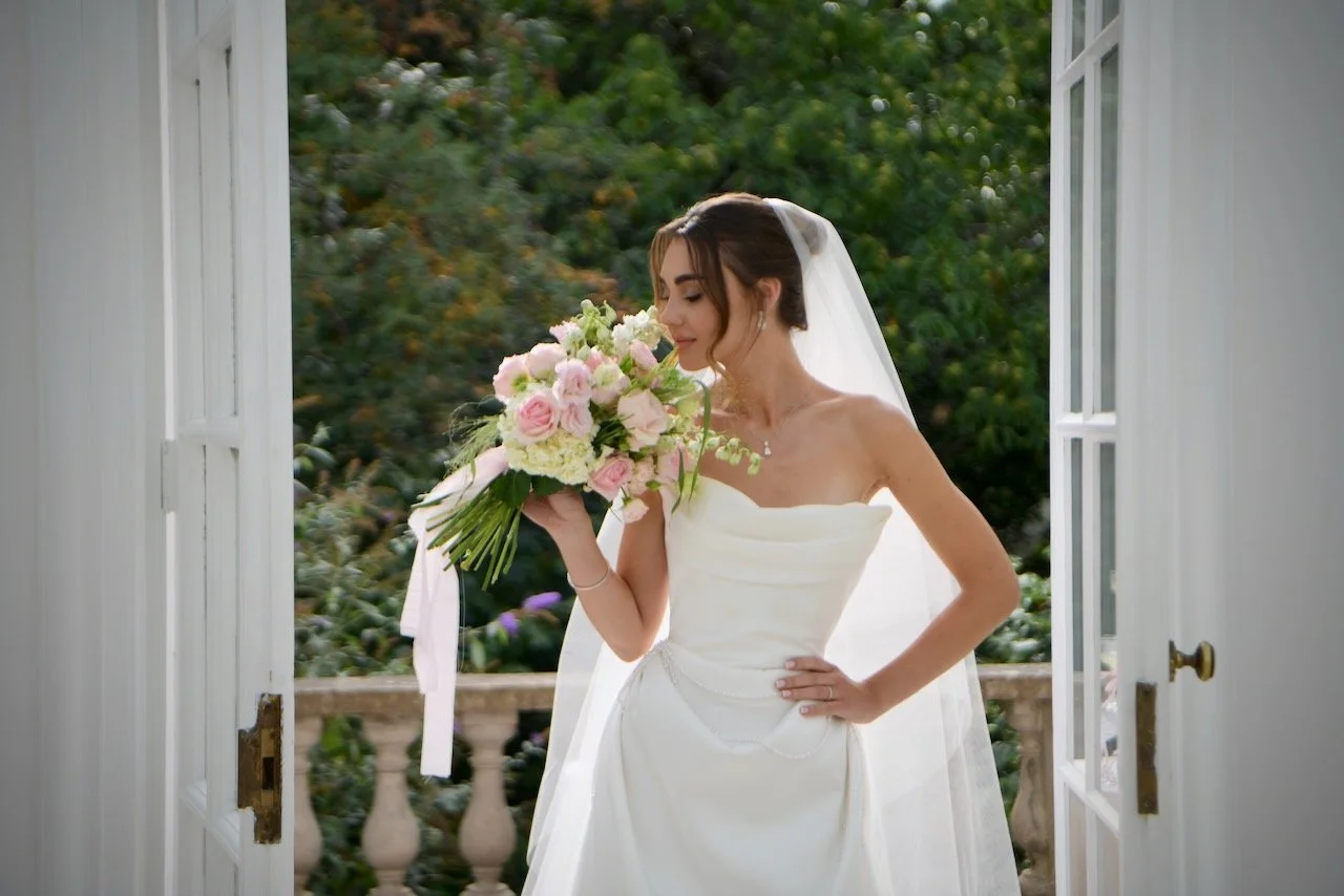 Bride smelling her stunning bouquet, London garden