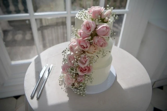 Beautiful wedding cake in sunlit room 