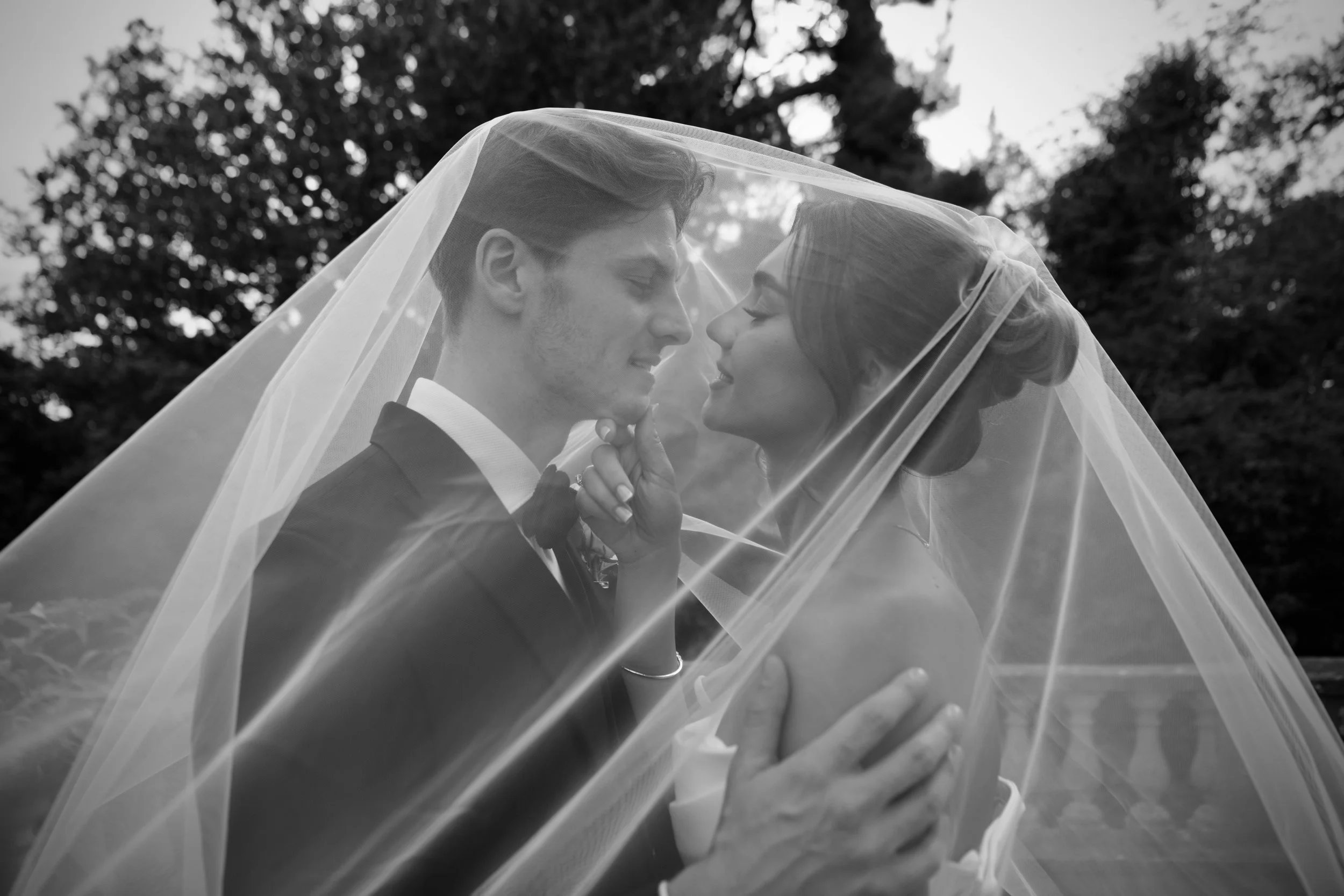Bride and groom sharing an intimate moment beneath the veil at a London wedding
