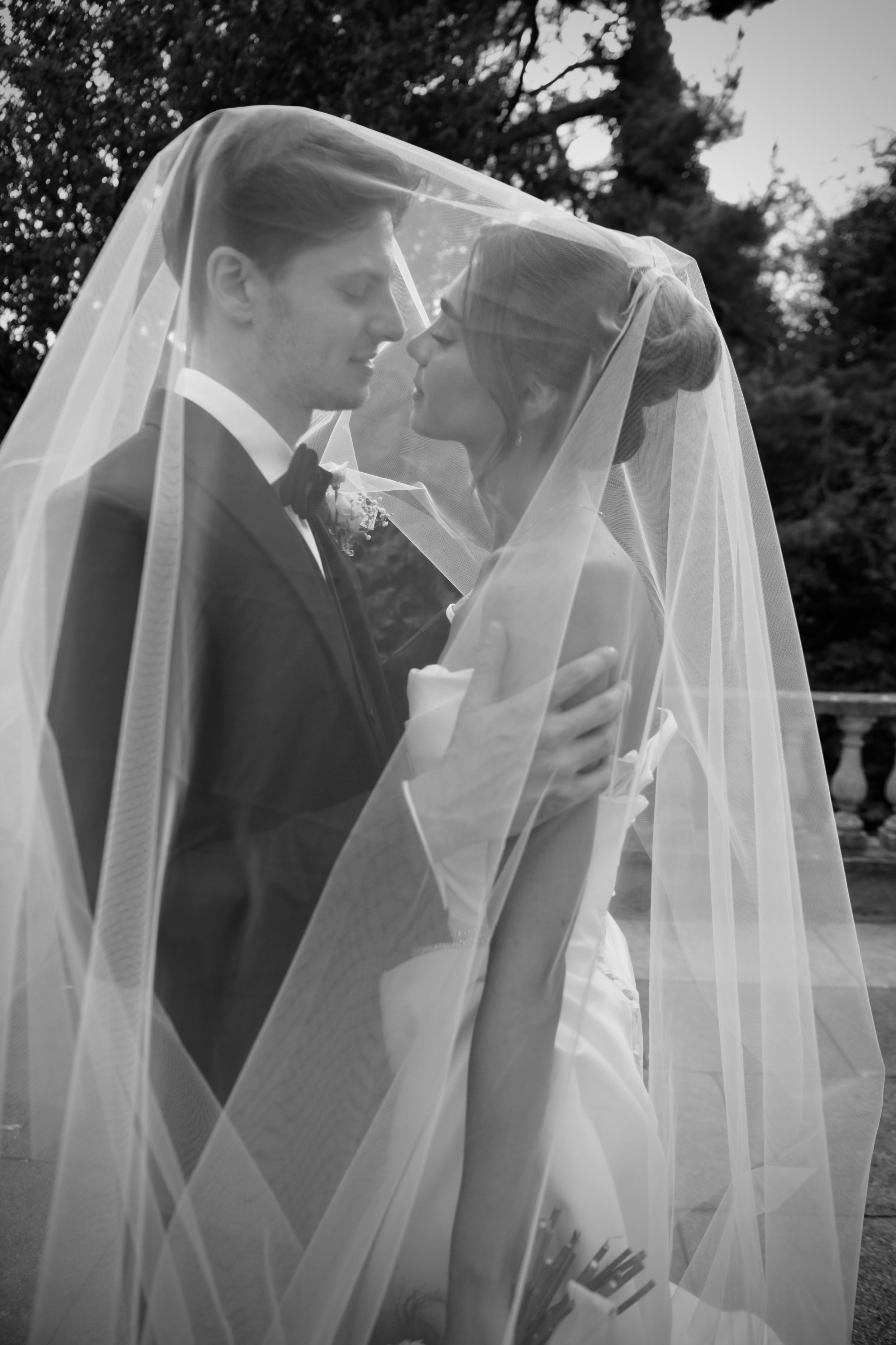 Bride and groom sharing an intimate moment beneath the veil at a London wedding