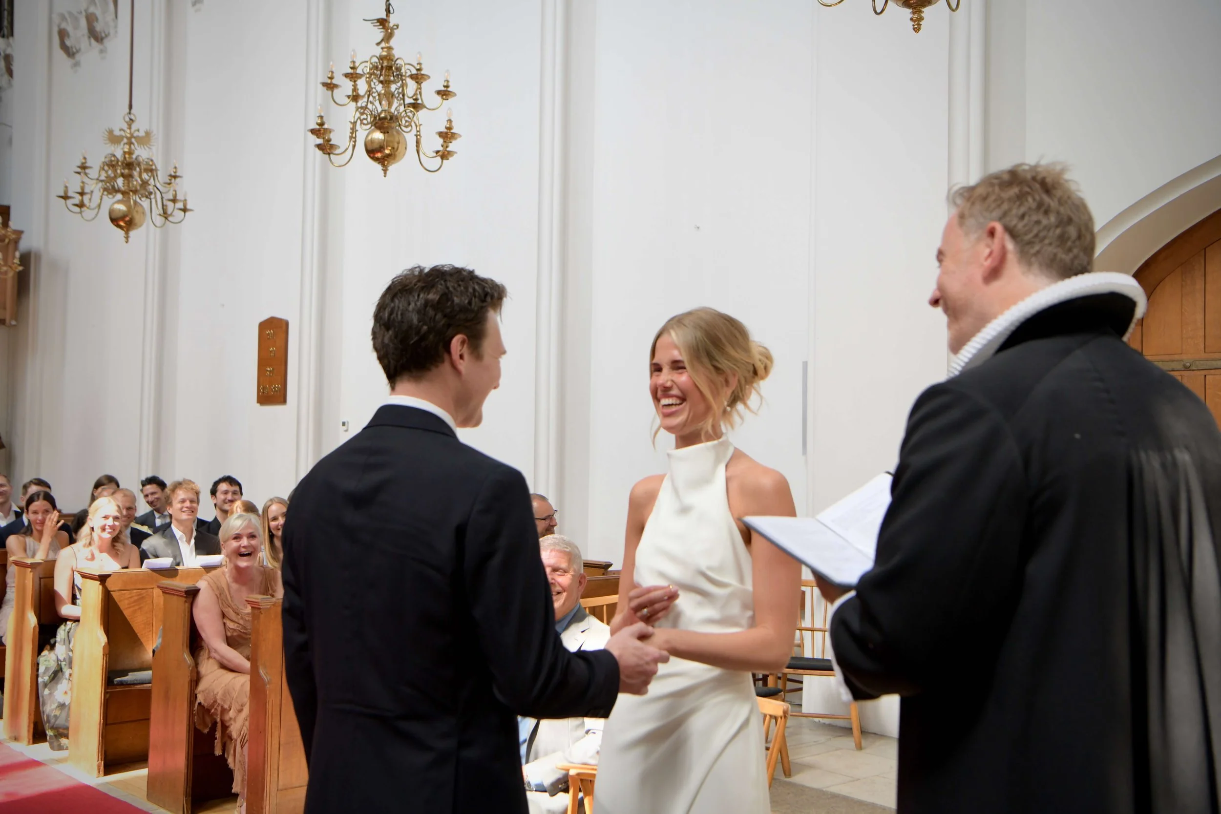 Elegant church wedding ceremony in London featuring a couple exchanging vows with timeless historic architecture. Perfect inspiration for classic and luxury wedding photography.