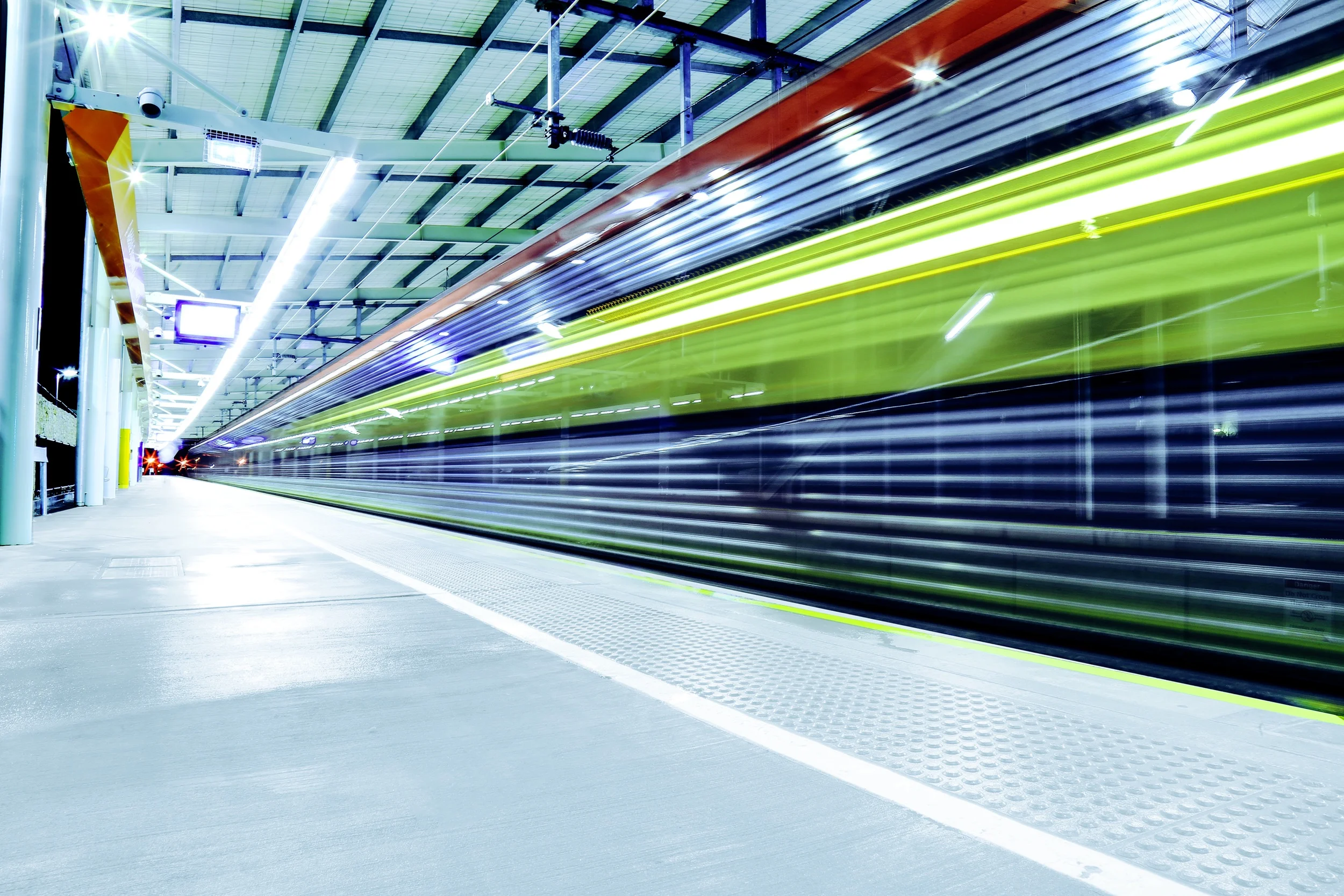 train-passing-through-illuminated-station