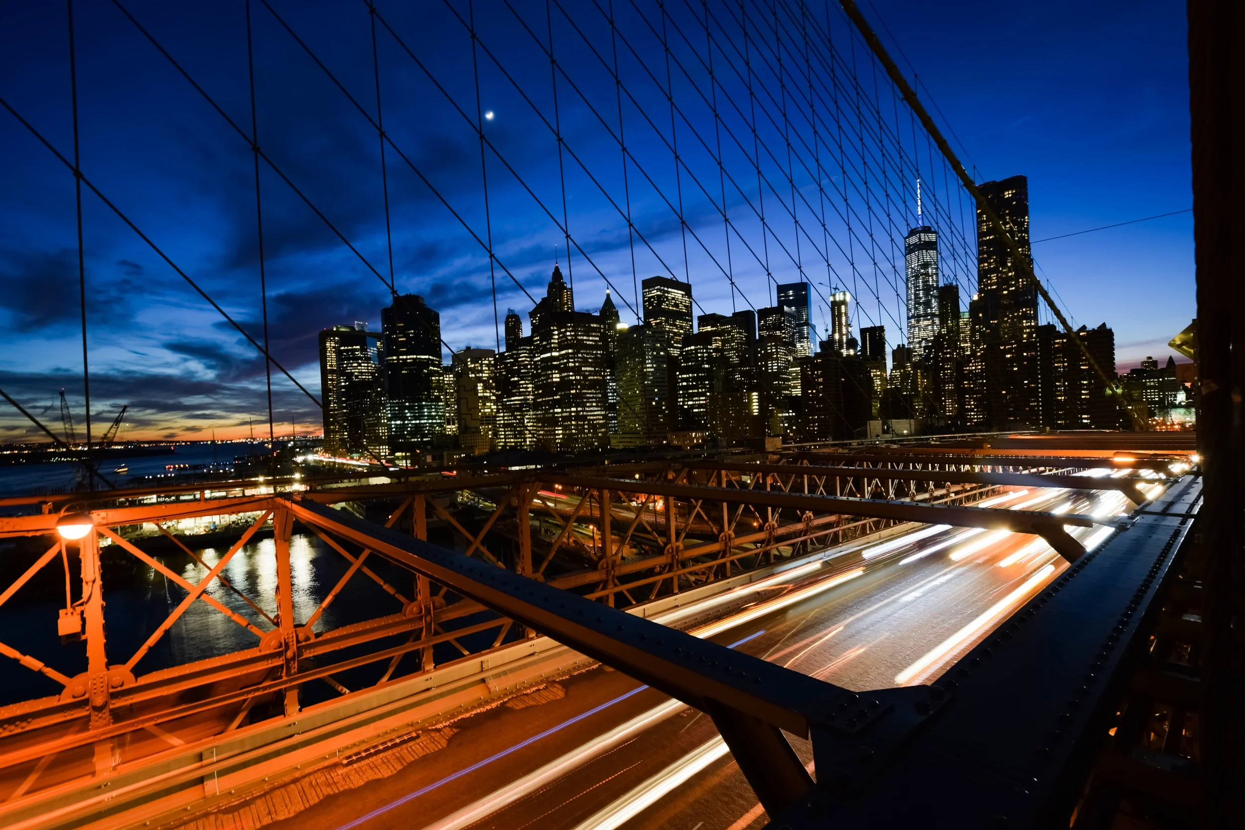 night-time-view-of-train-heading-over-bridge-to-city