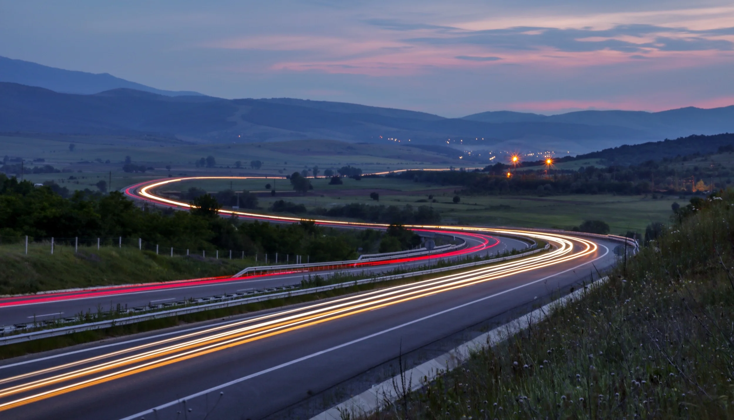 blurred-headlights-flowing-along-country-road