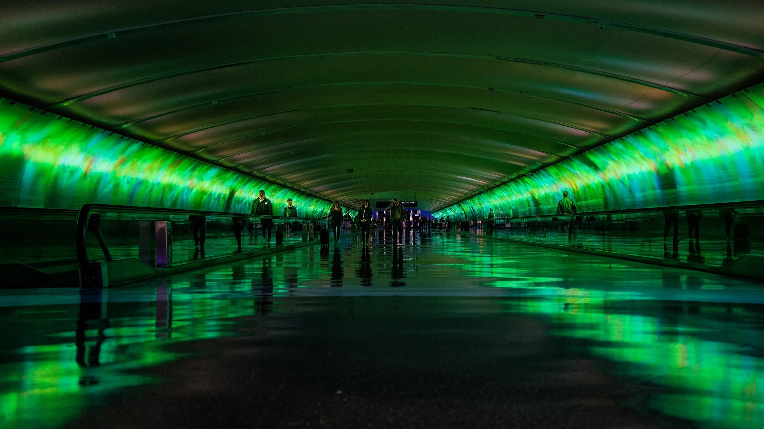 illuminated-green-subway-with-travellator-and-people