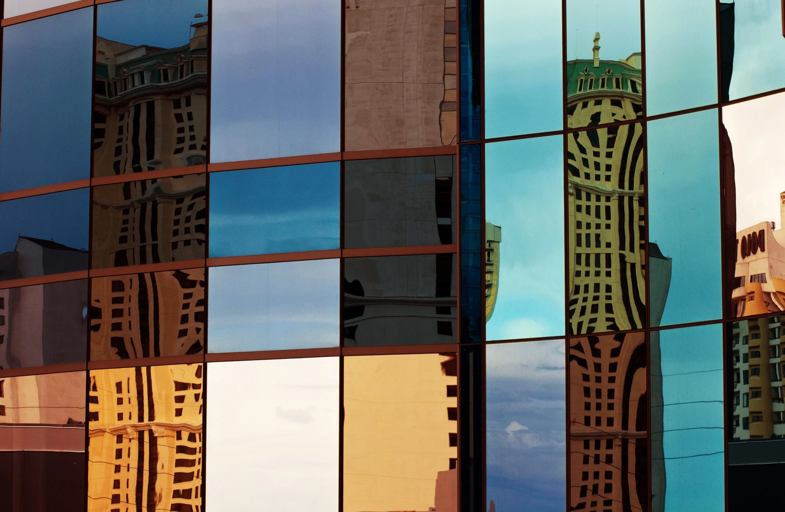 buildings-reflected-in-external-mirror-glass
