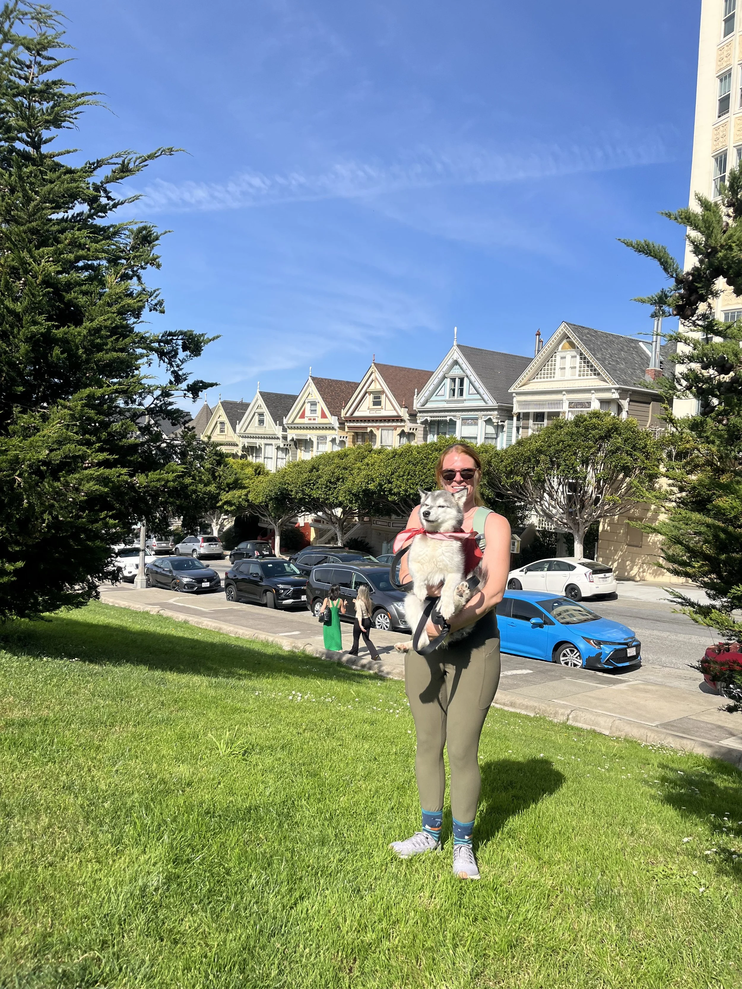 Puppy and his owner posing in front of the Painted Ladies in Alamo Square.jpeg