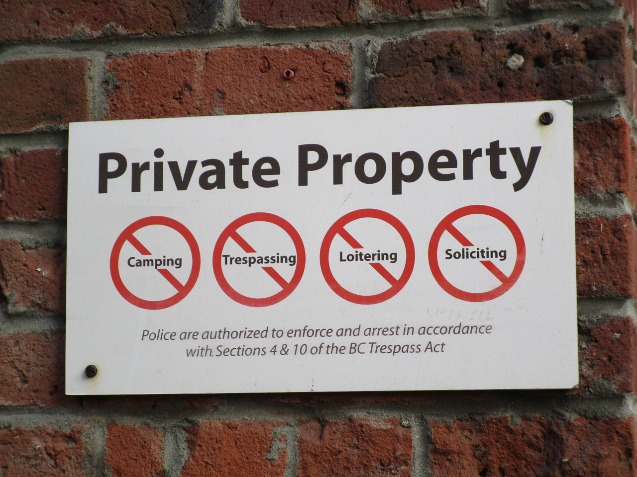 "Private Property. No camping, trespassing, loitering, or soliciting. Police are authorized to enforce and arrest in accordance with Sections 4 & 10 of the BC Trespass Act."