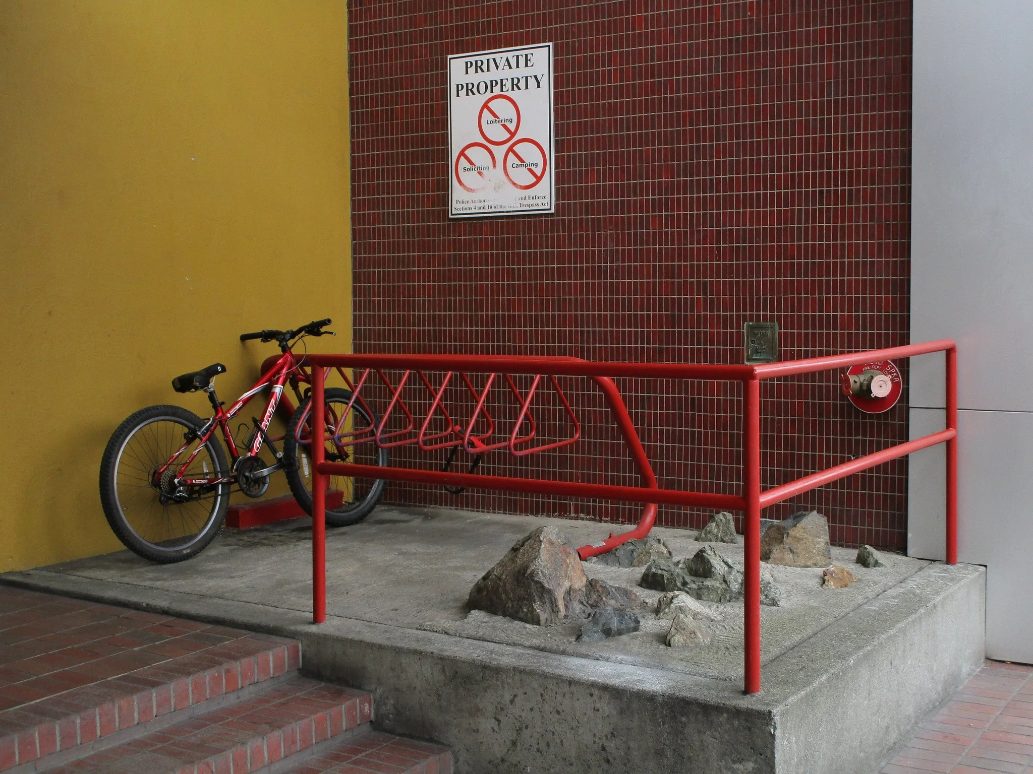 Rocks and "Private Property" sign at 1250 Quadra.