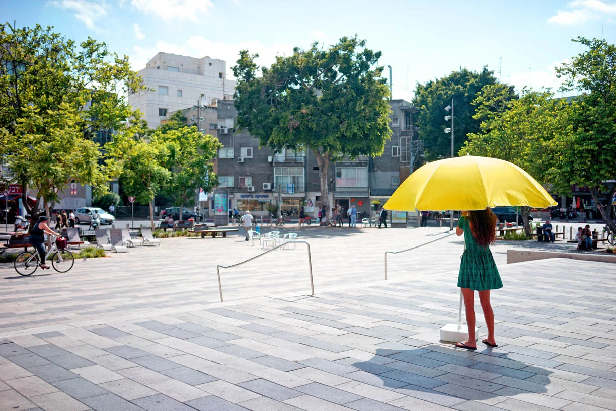 Tel Aviv, people in the city, summer, girl with yellow umbrella