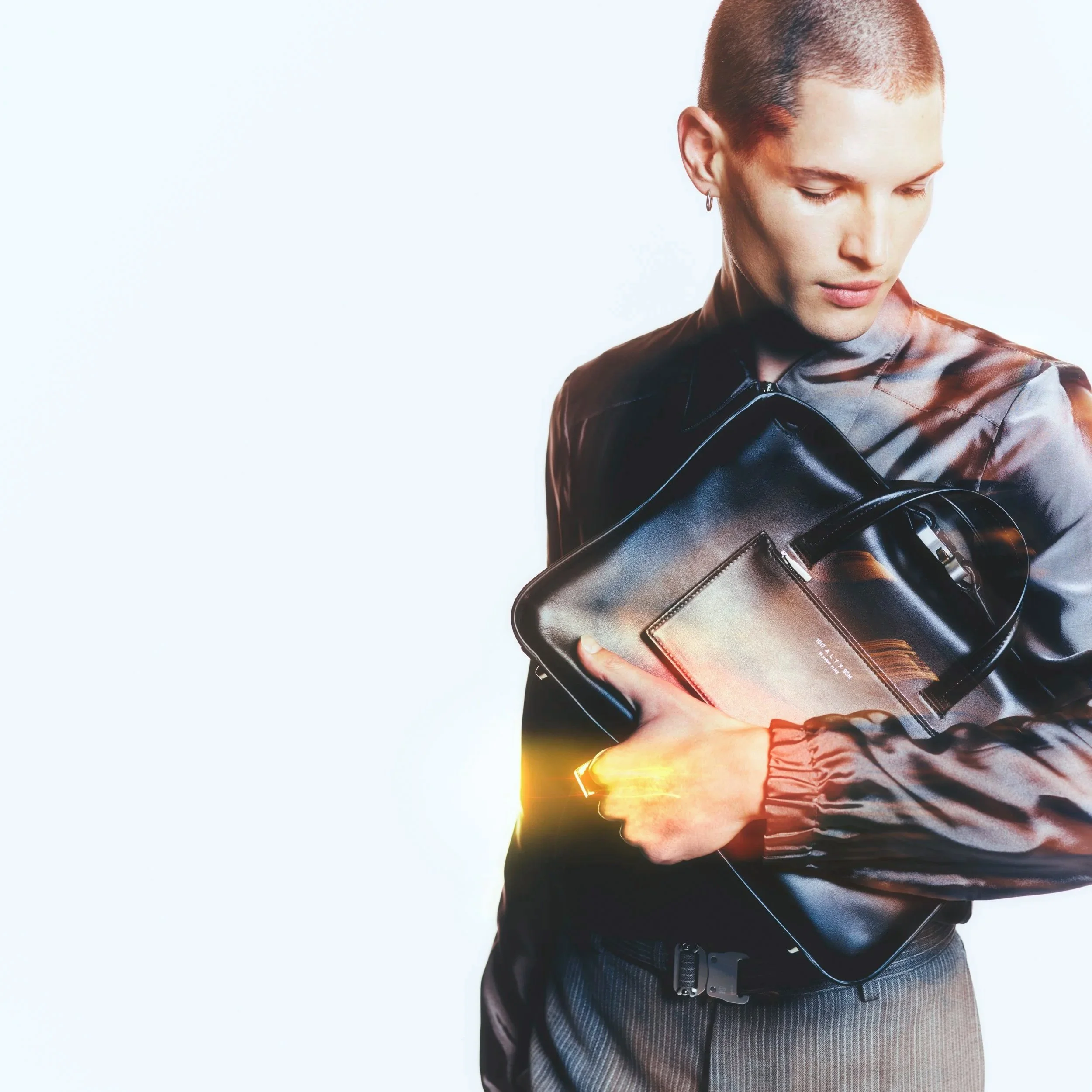 Jacket VALENTINO; trousers and bag 1017 ALYX 9SM, jewellery ALEXANDER MCQUEEN
