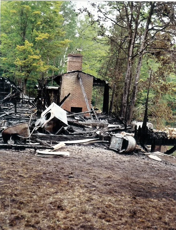 A burned out building with nothing left standing but the fireplace and chimney