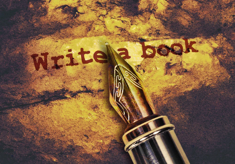Fountain pen over the words “write a book”