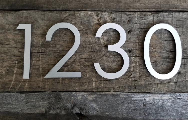 Dimensional address numbers on a wood background